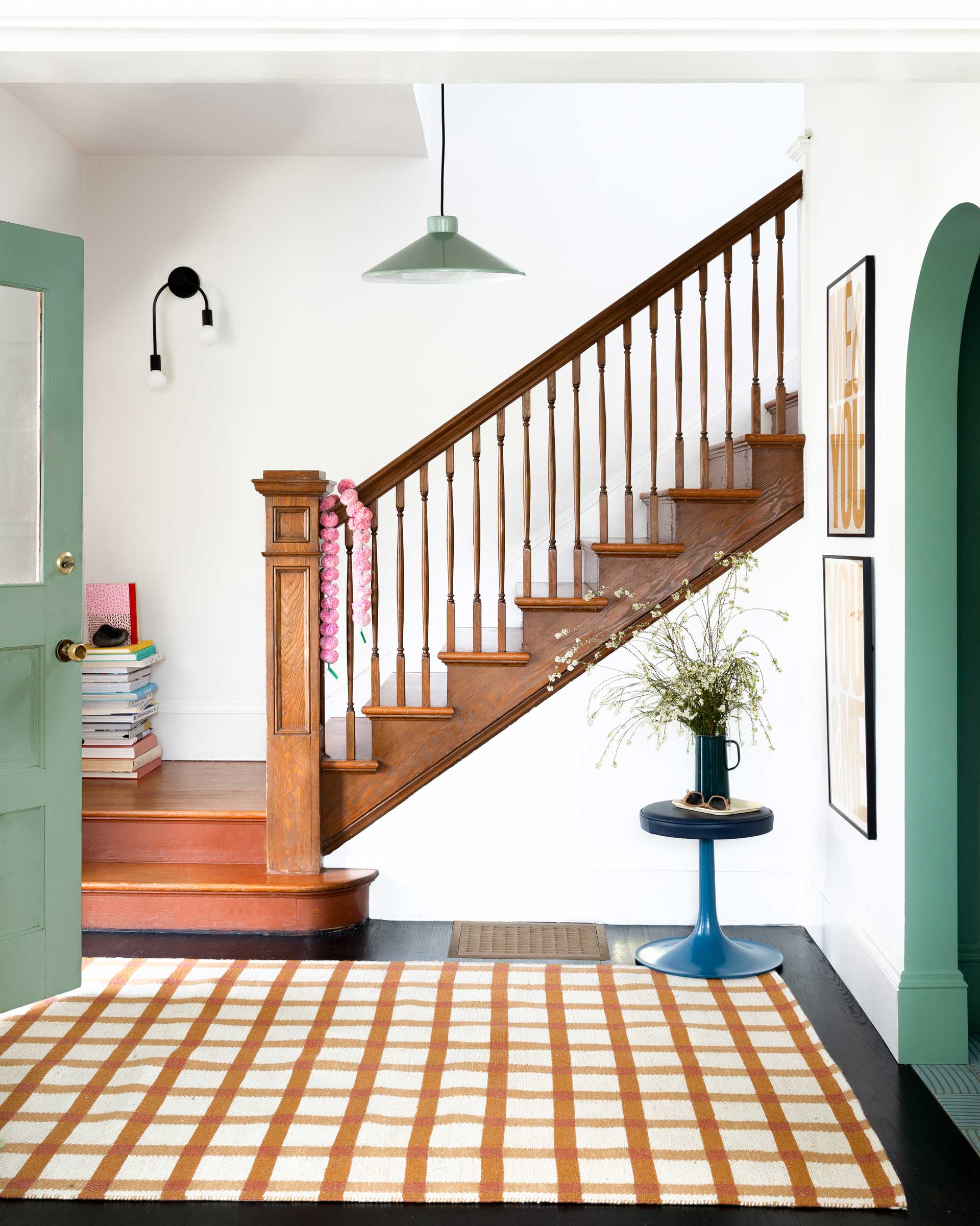 A spruce green Gantry Pendant in an entryway. 