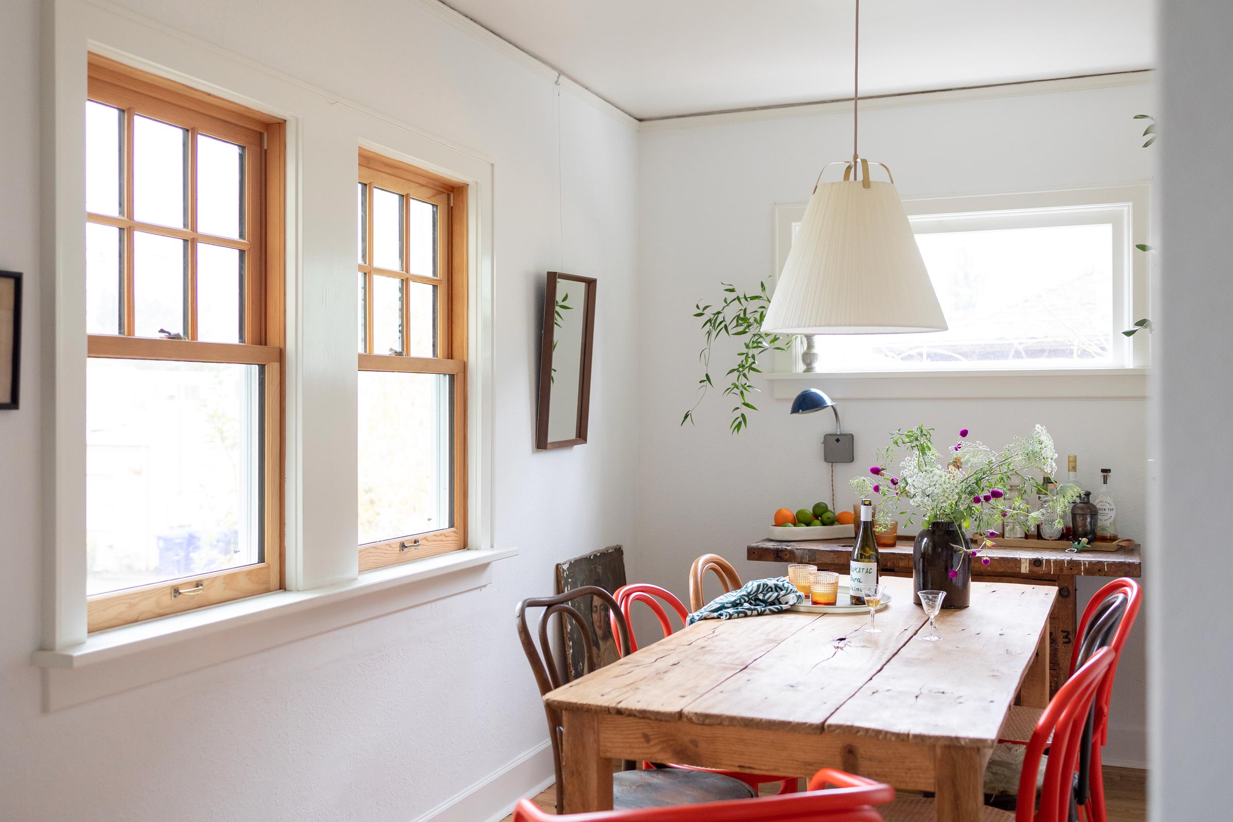 A light-filled dining room with a vintage-inspired fabric shade pendant. 