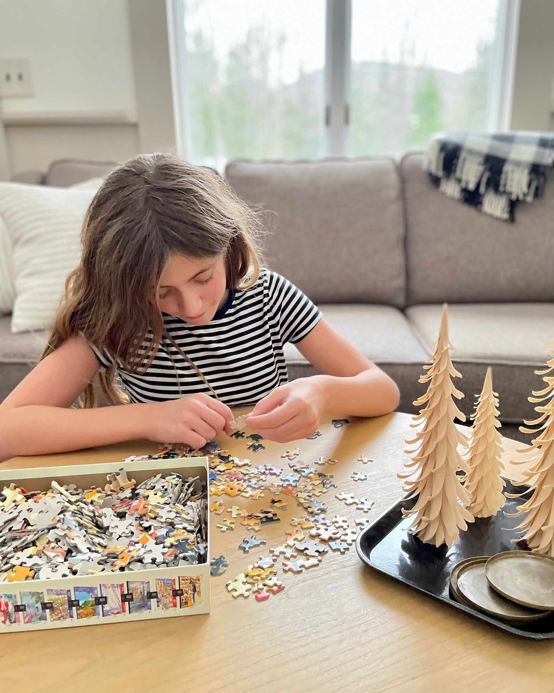 A girl working on a puzzle.