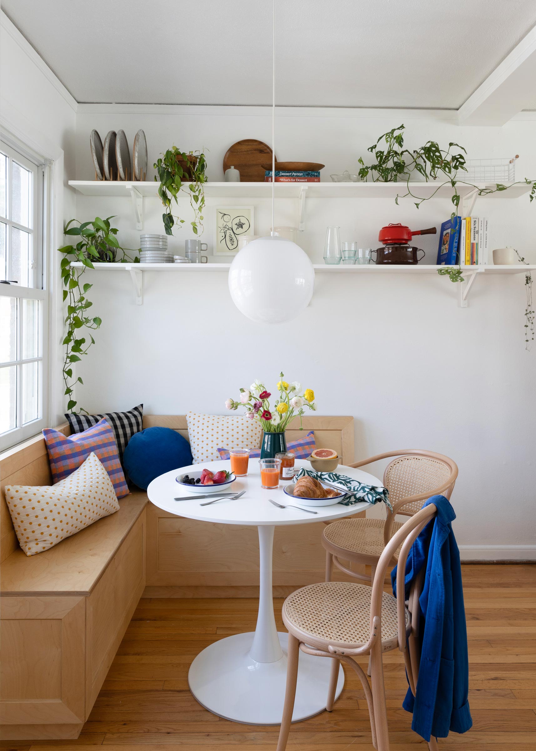 A globe pendant in an apartment breakfast nook.