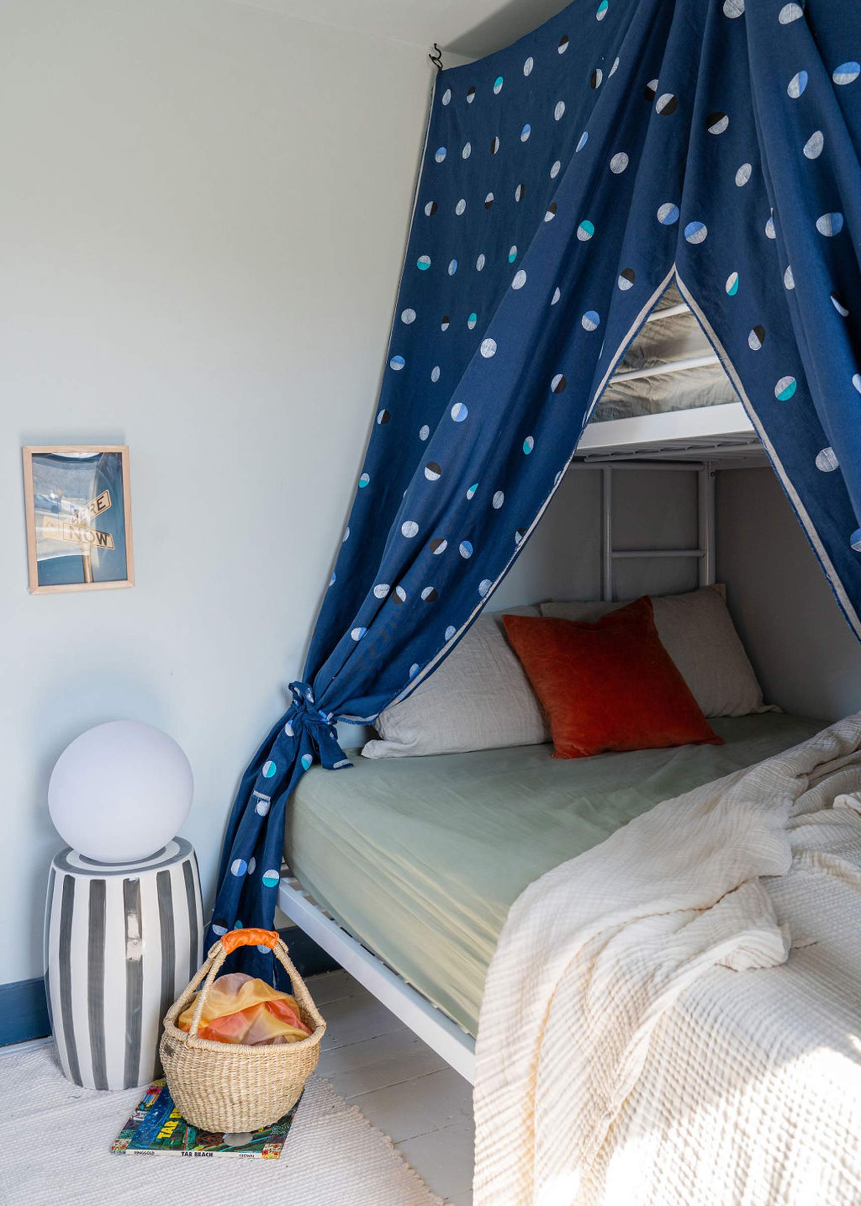 A kid's room with bunkbeds and a canopy. 