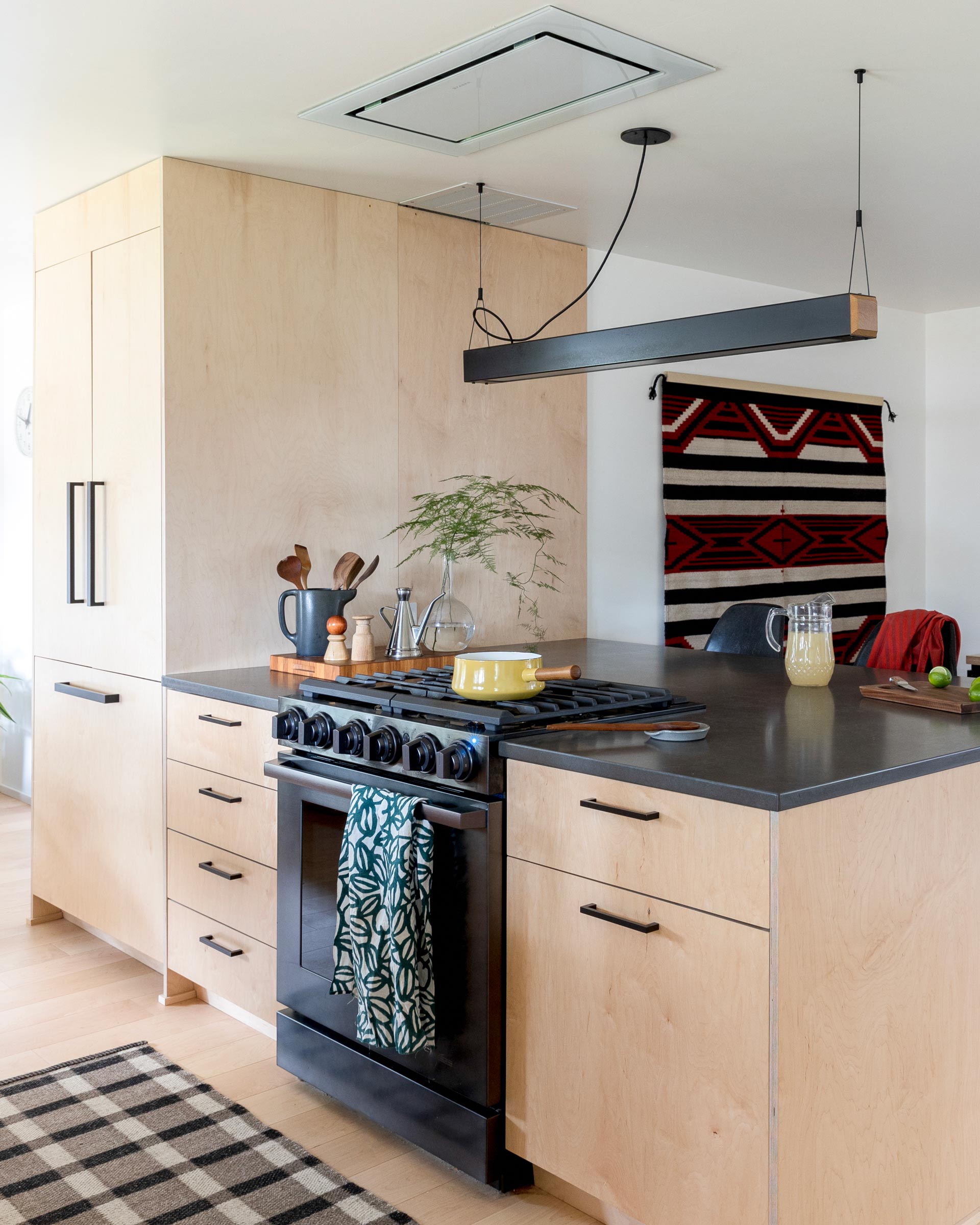 A minimal kitchen with a modern chandelier over the island