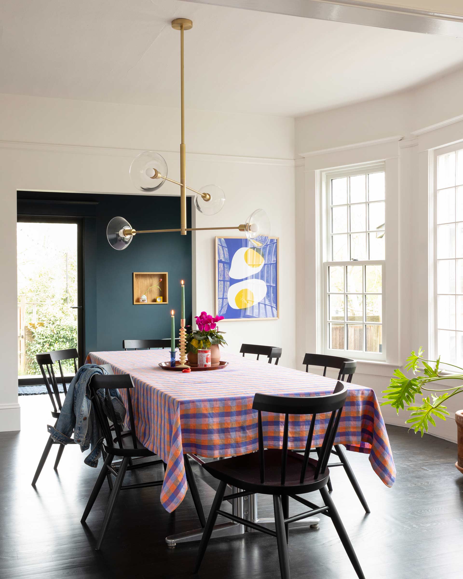 A modern chandelier in a dining room.