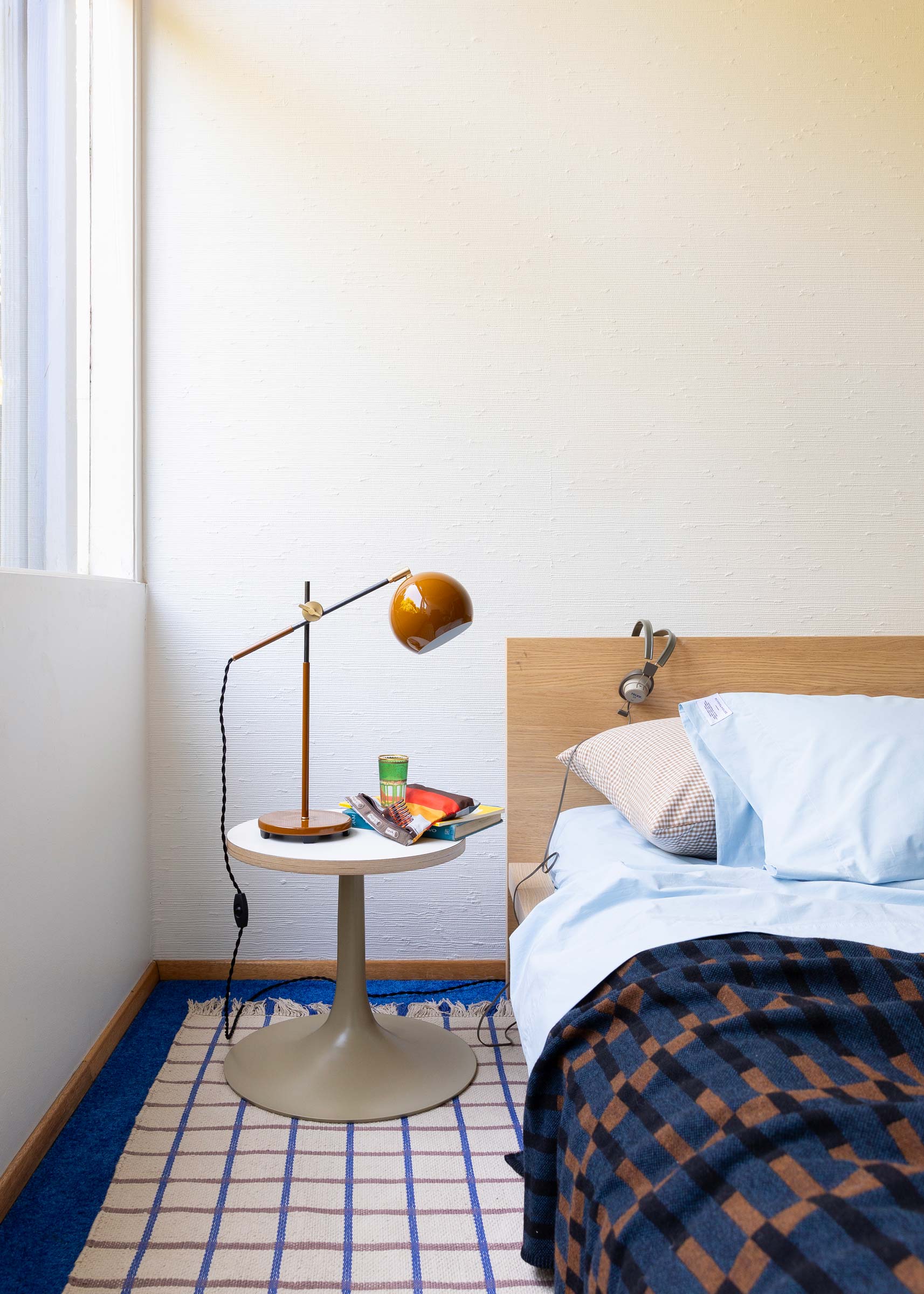 A modern cotton grid flatweave area rug in a bedroom.