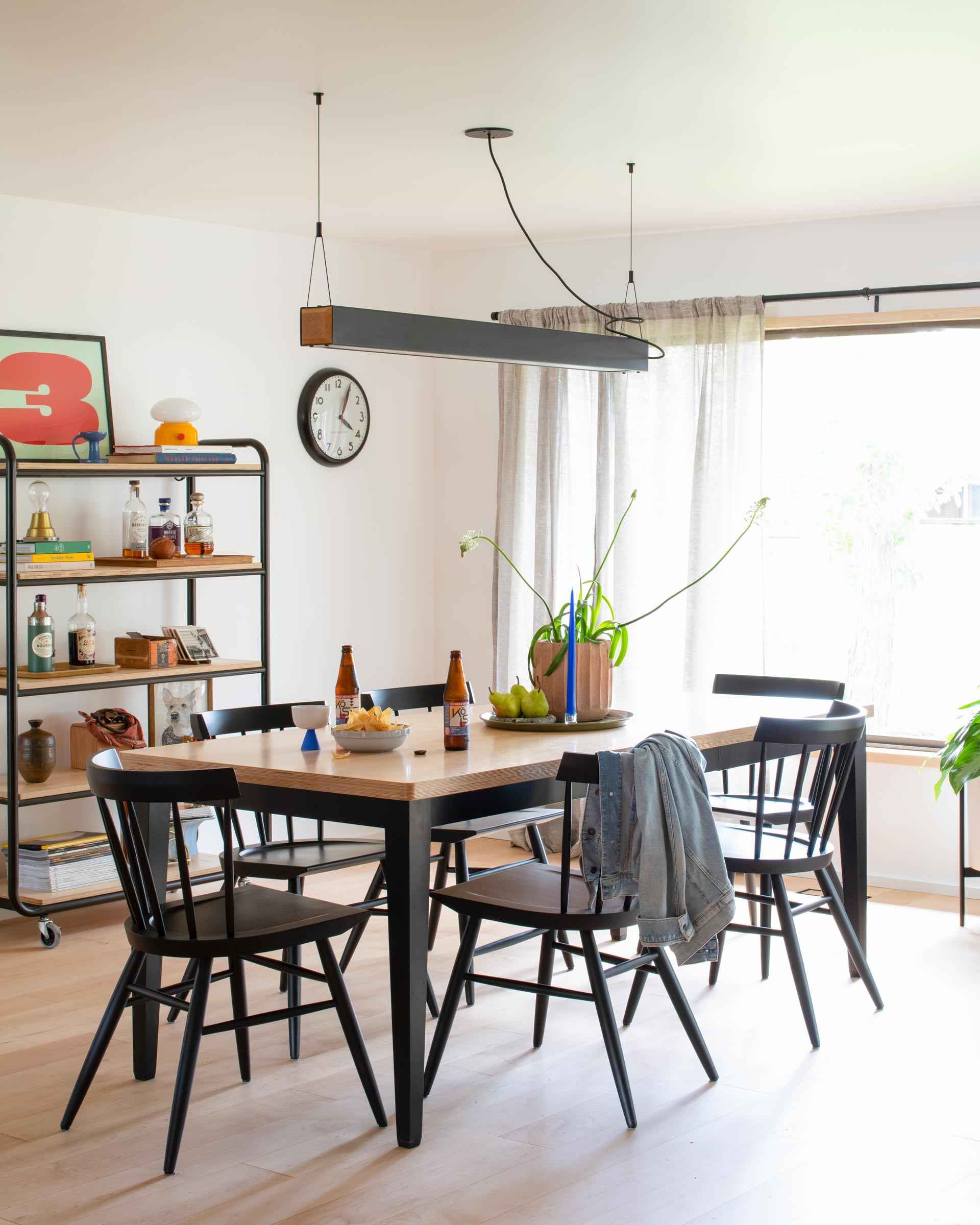 A modern dining room with a Penn Chandelier.  