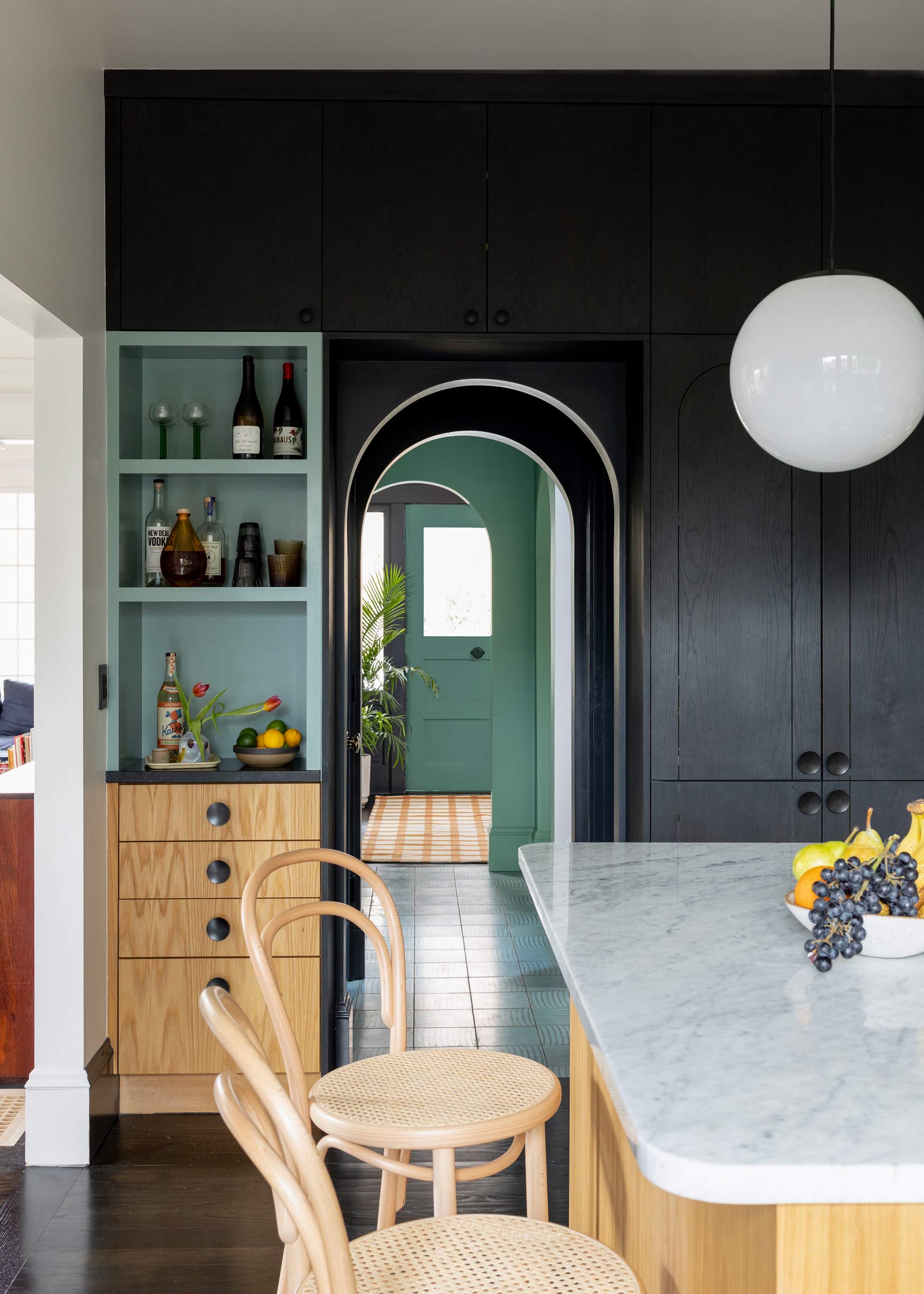 A modern kitchen with an arched entryway. 