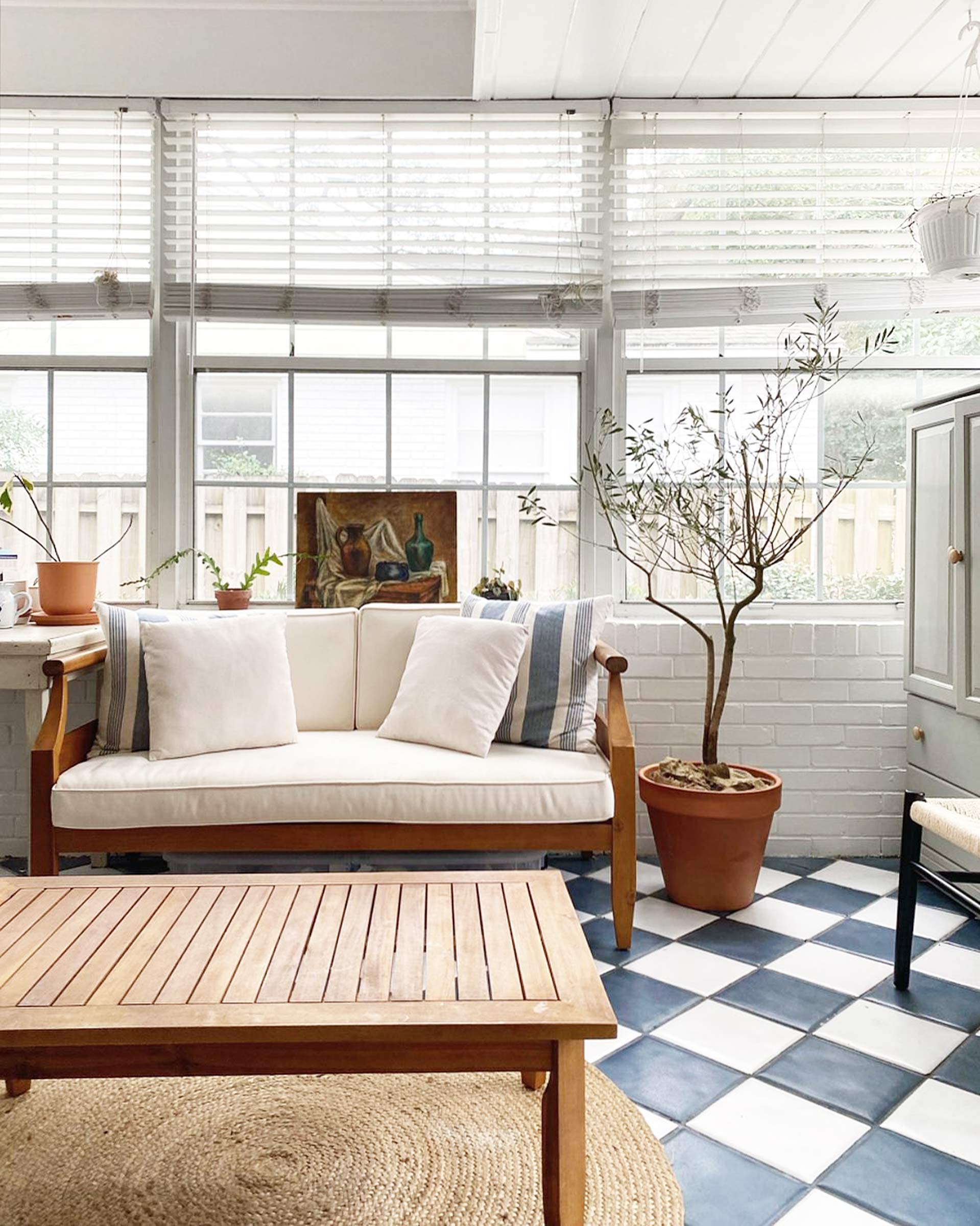 A large sunroom with blue and white tile. 