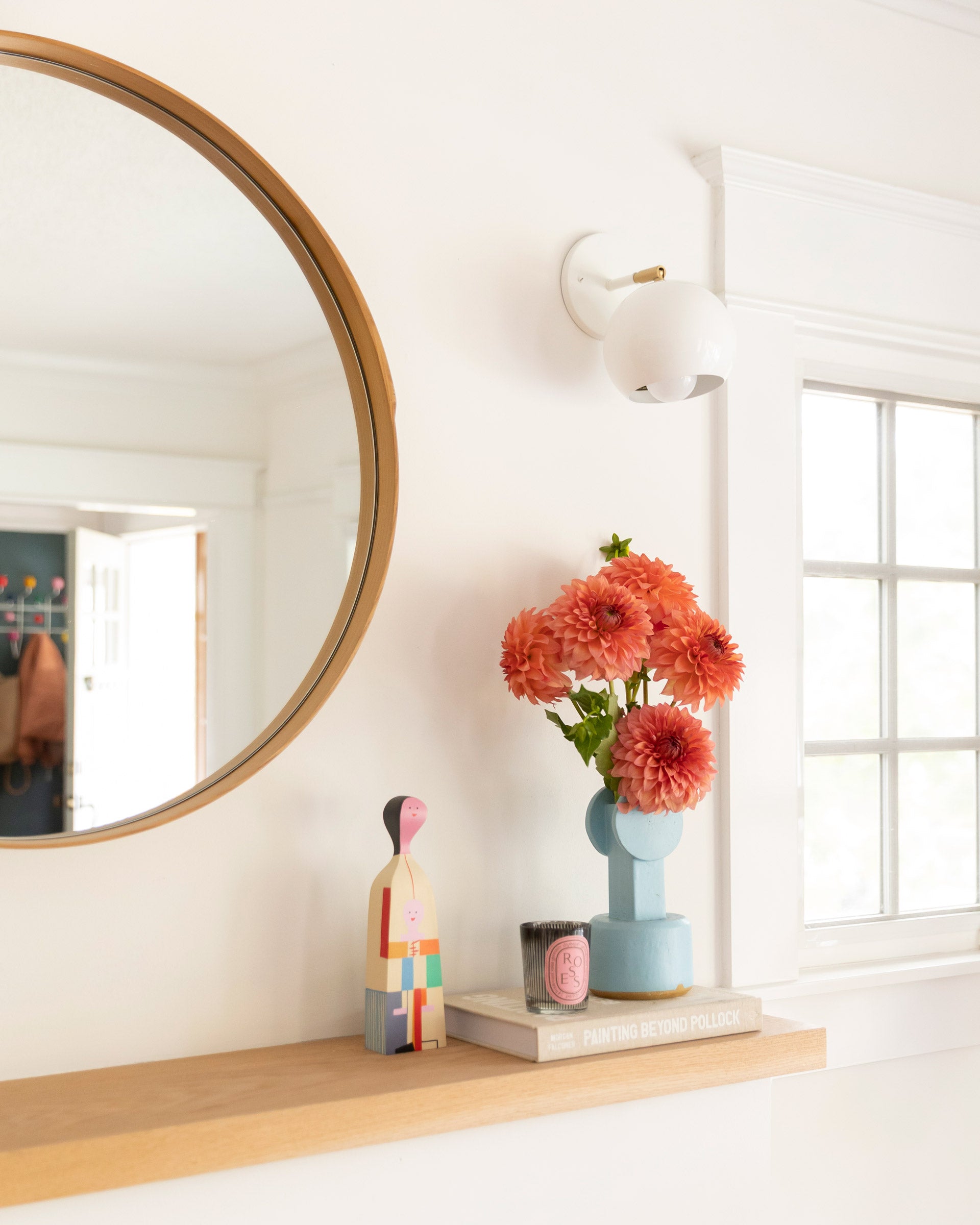 A wall sconce above a mantel.
