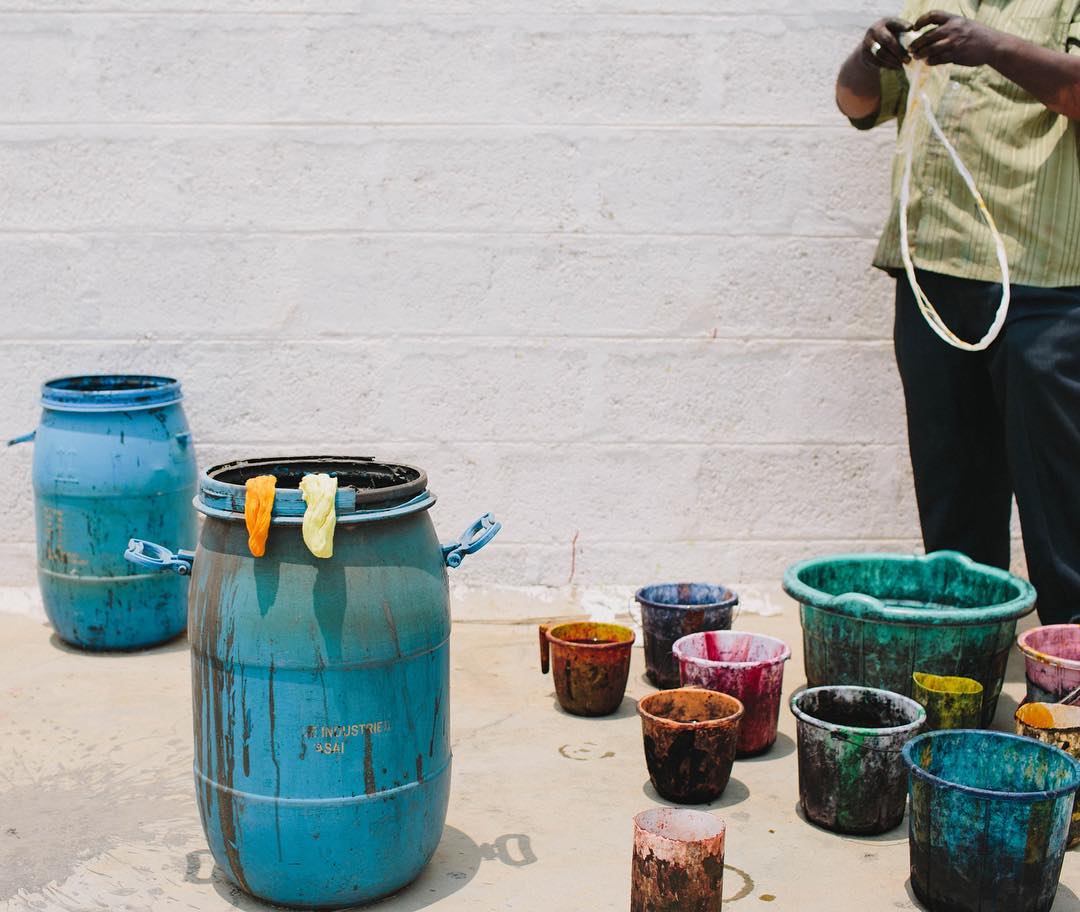 person taking a picture of a group of buckets