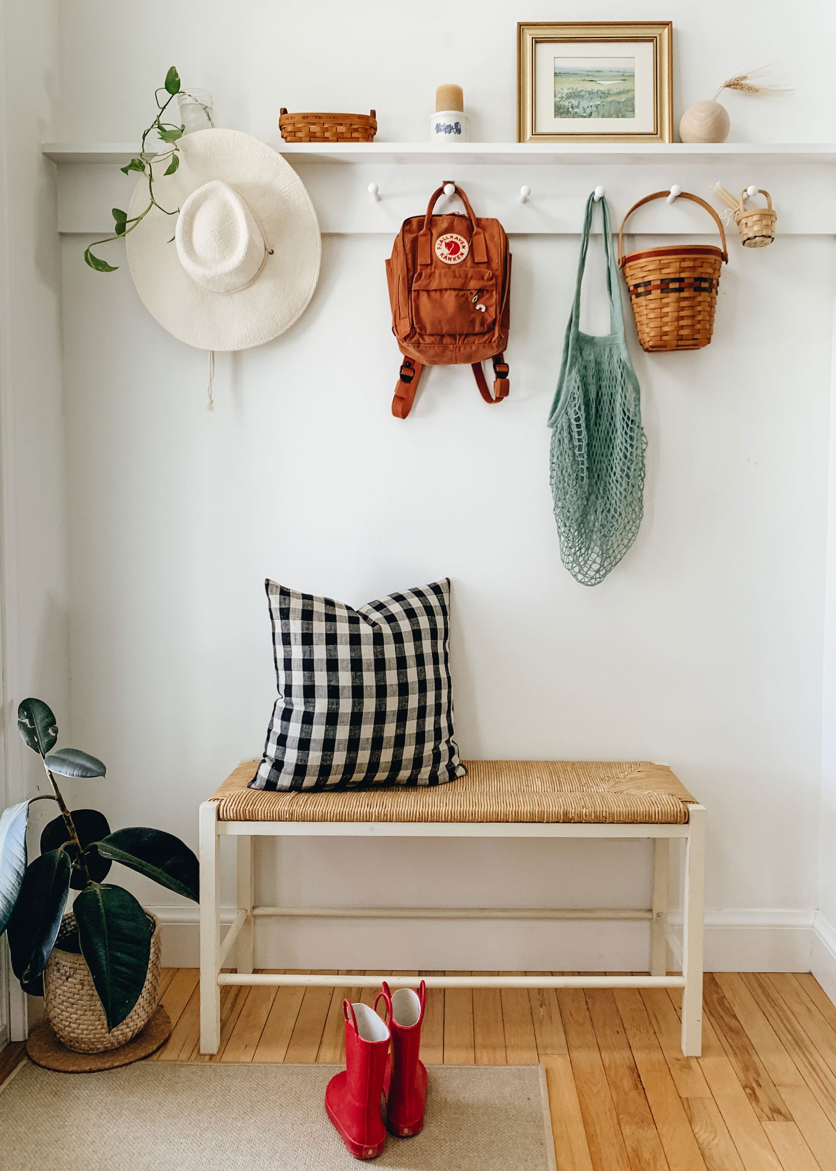 An entryway with a peg rail and a sitting bench. 