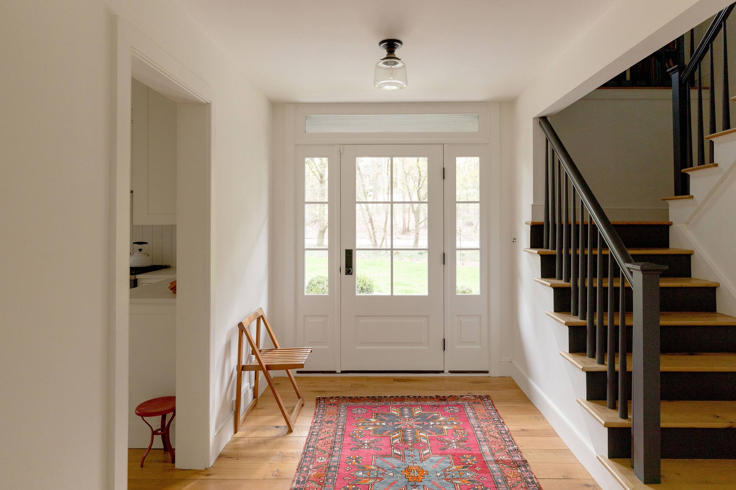 An open entryway with a schoolhouse surface mount. 