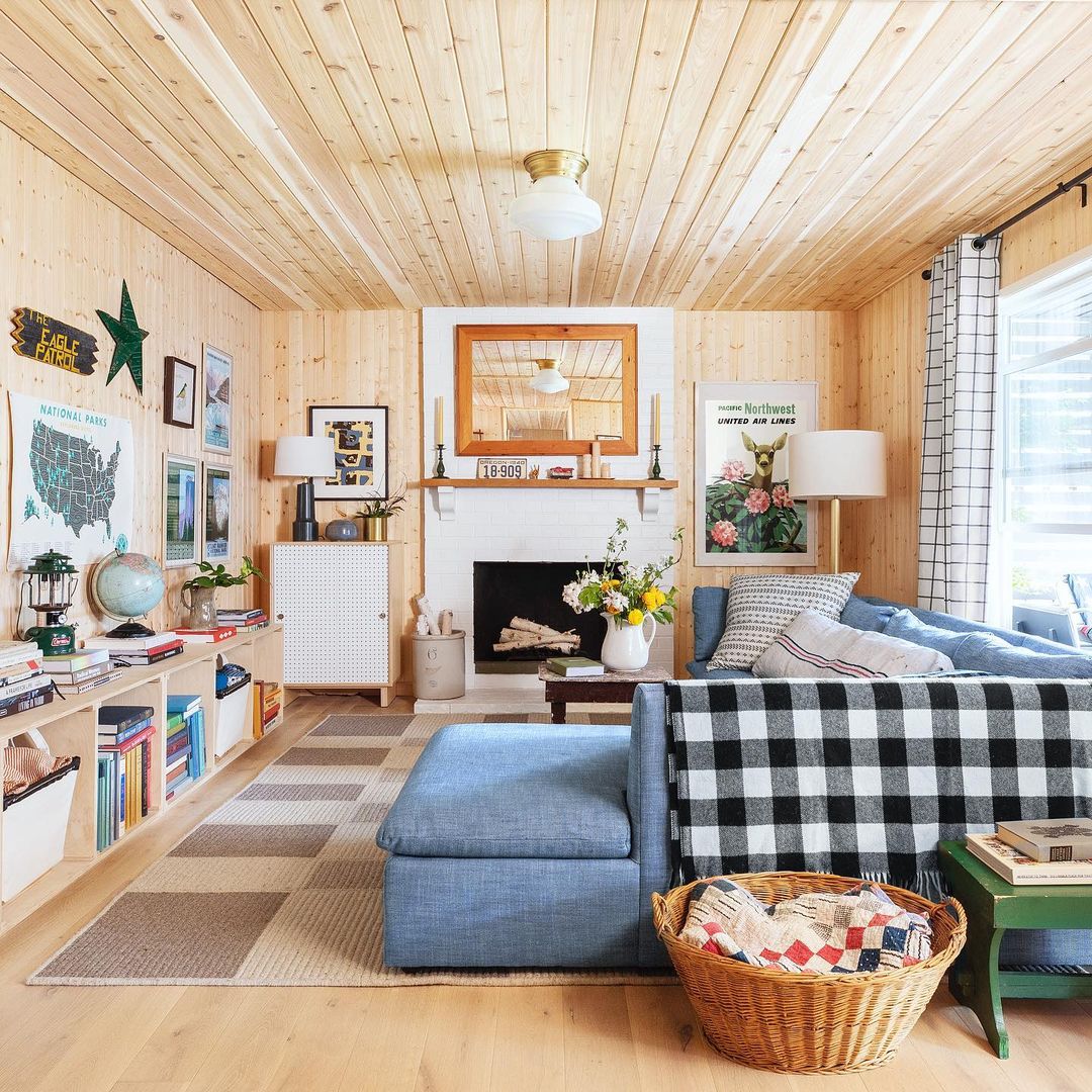 living room with a blue couch and a black and white blanket