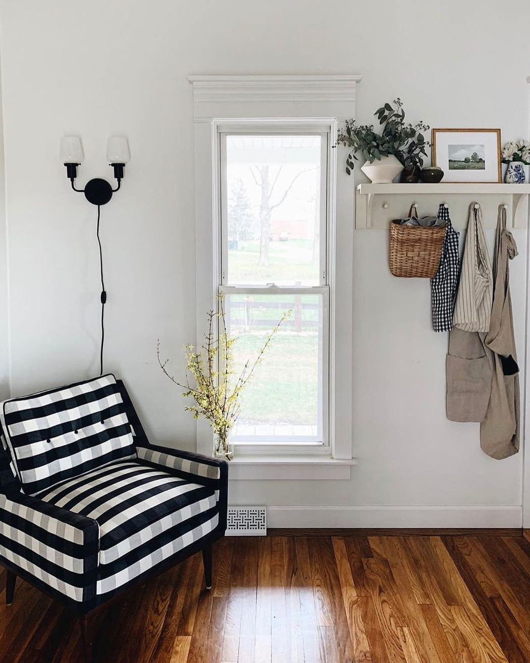 room with a black and white checkered chair and a window