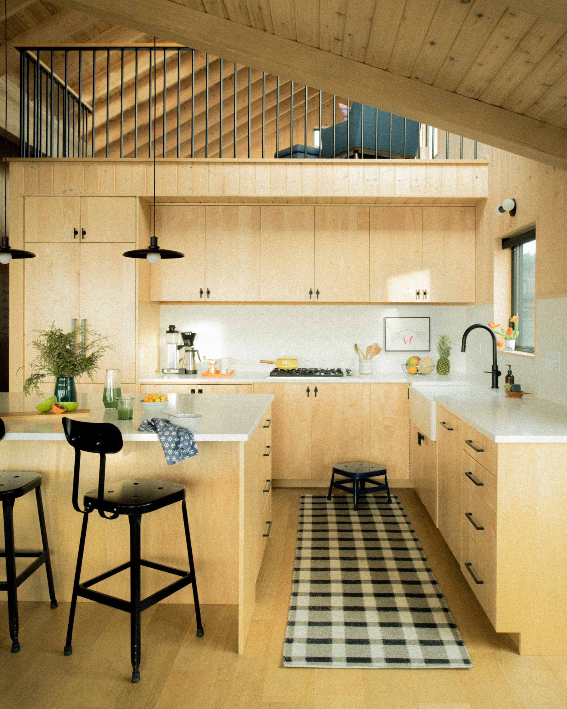 A modern kitchen with pendants over the island.