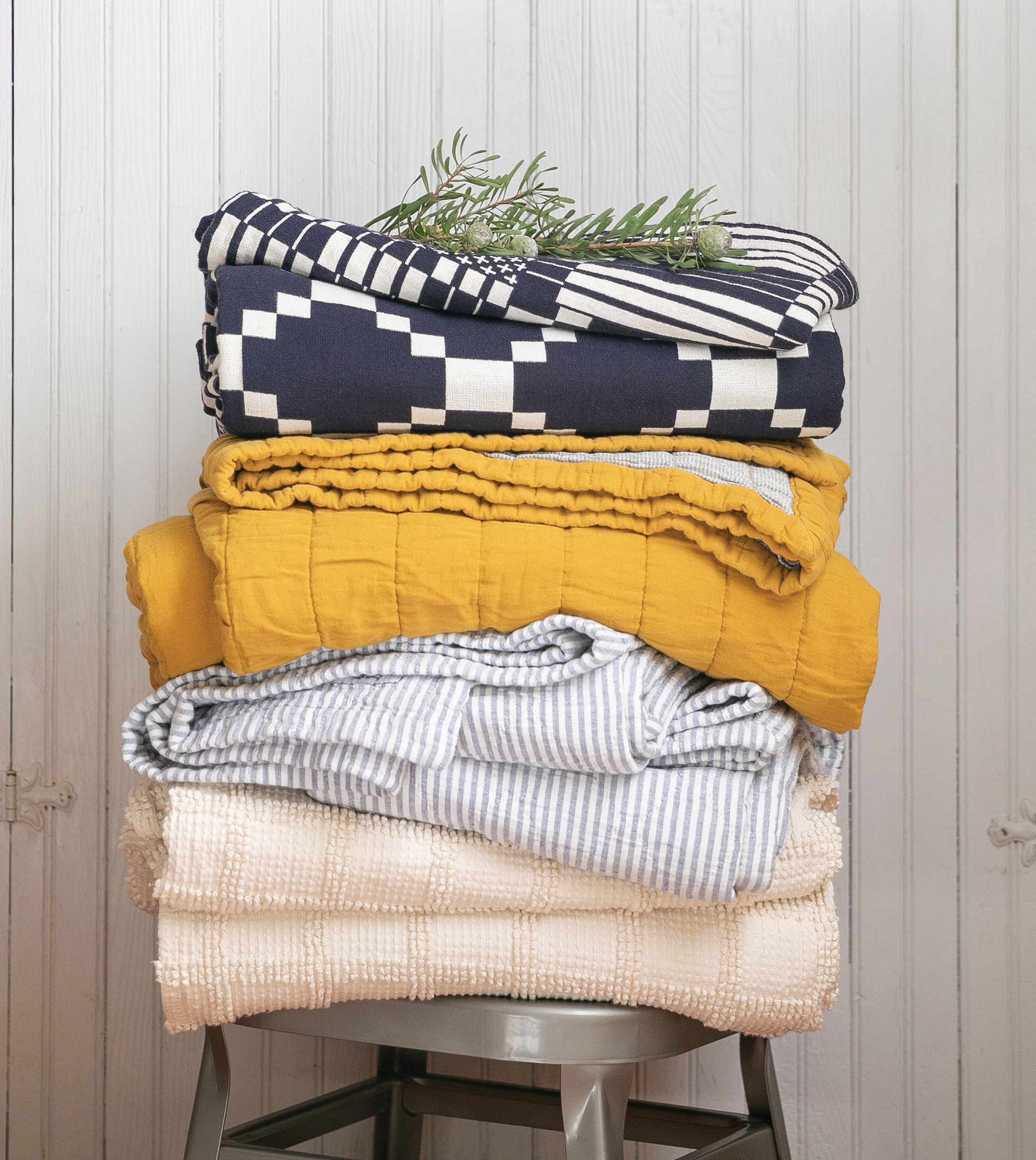 A bedding stack with a sprig on pine on top.