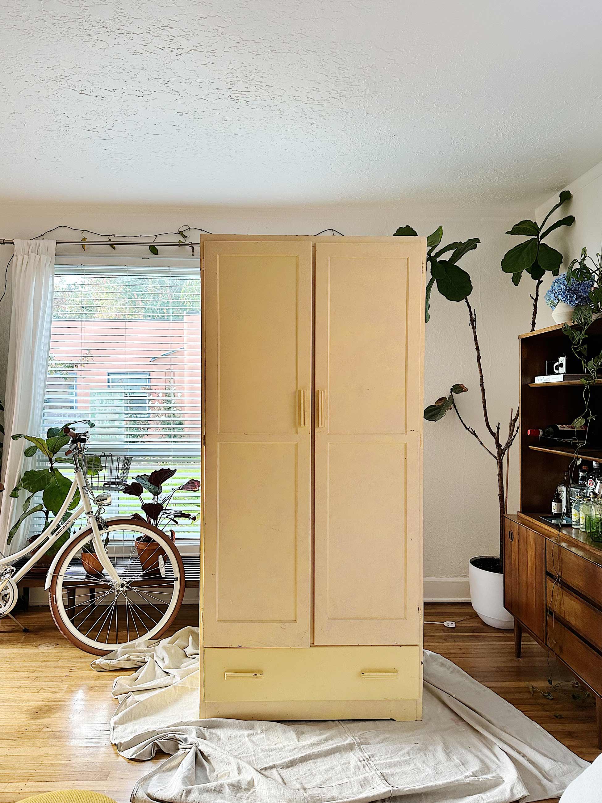 Armoire on top of drop cloth ready to be painted in living space.