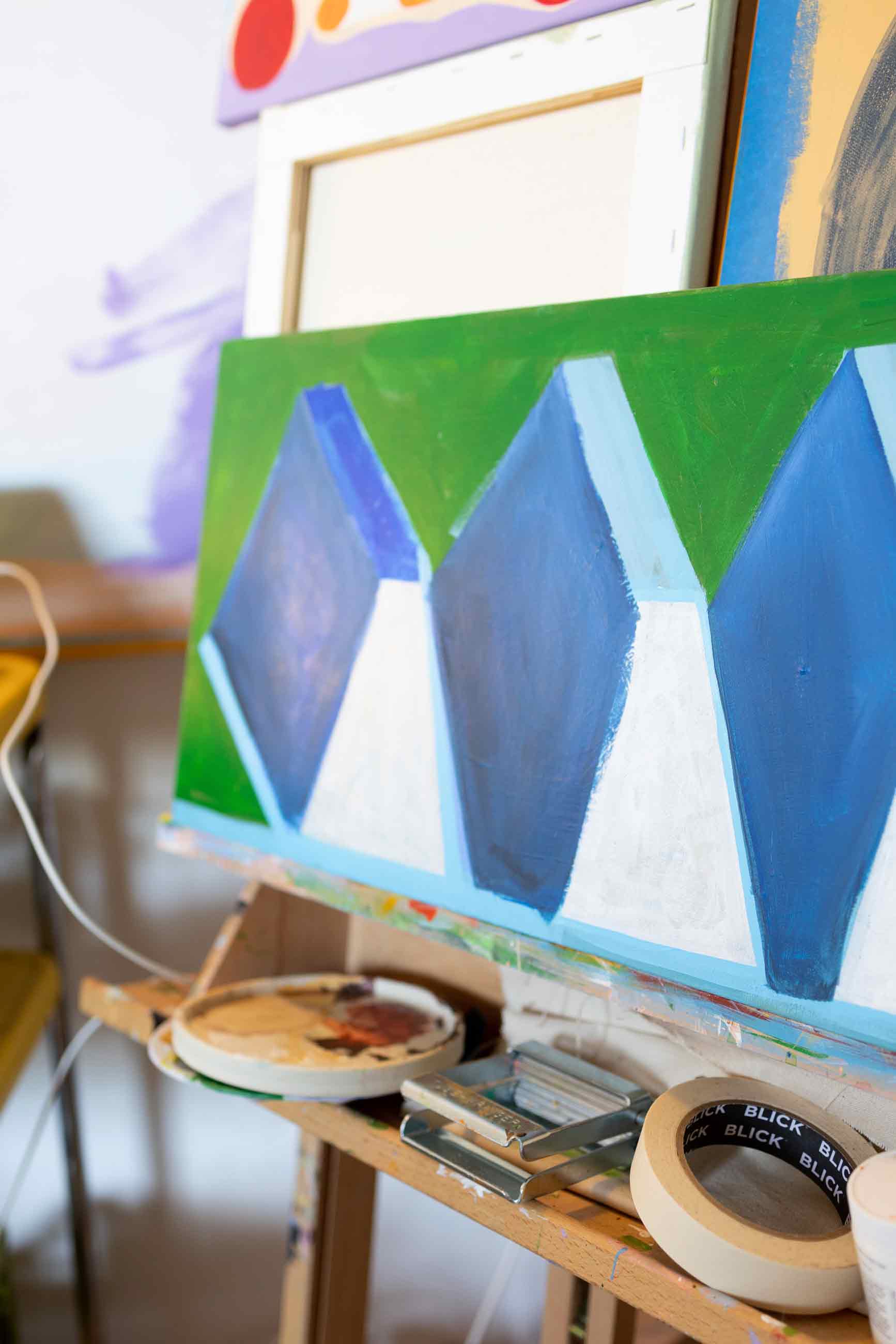 Up close image of a blue and green painting in progress.