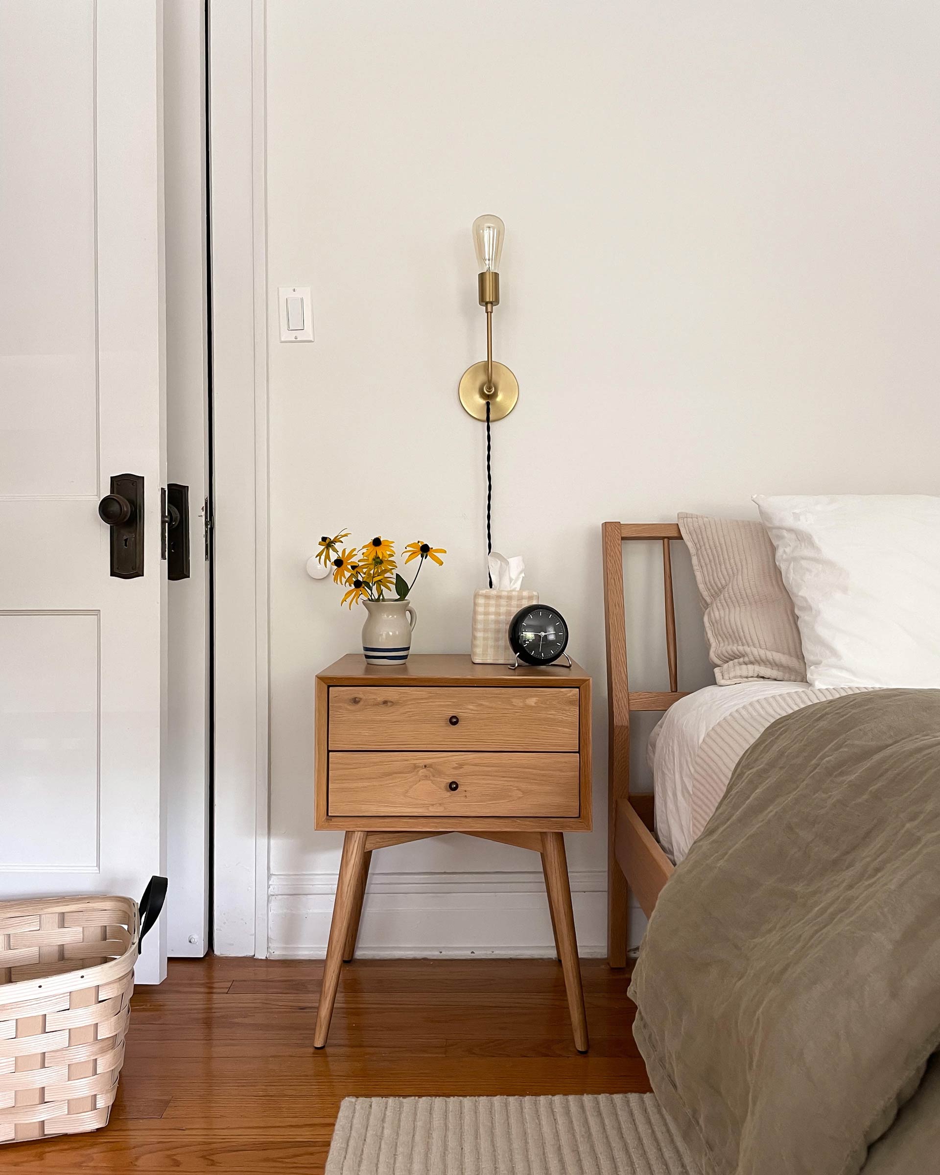 Brass plug-in wall sconces flanking the bed.