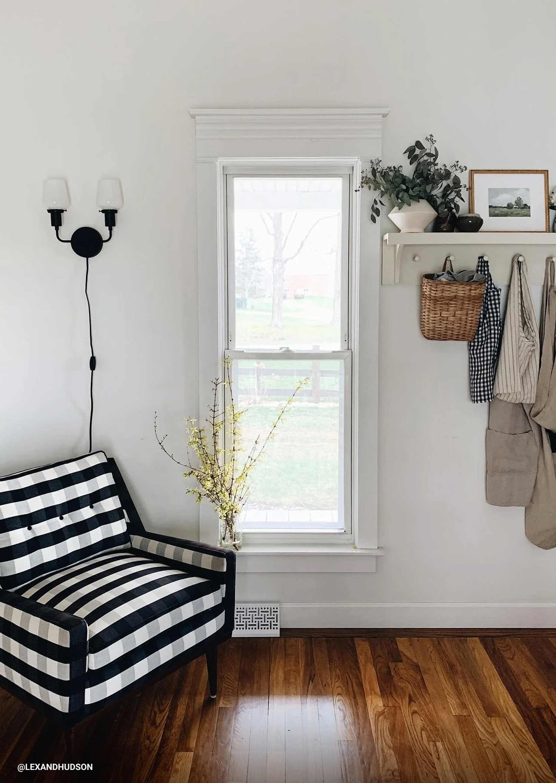 Checkered armchair in entryway space. 