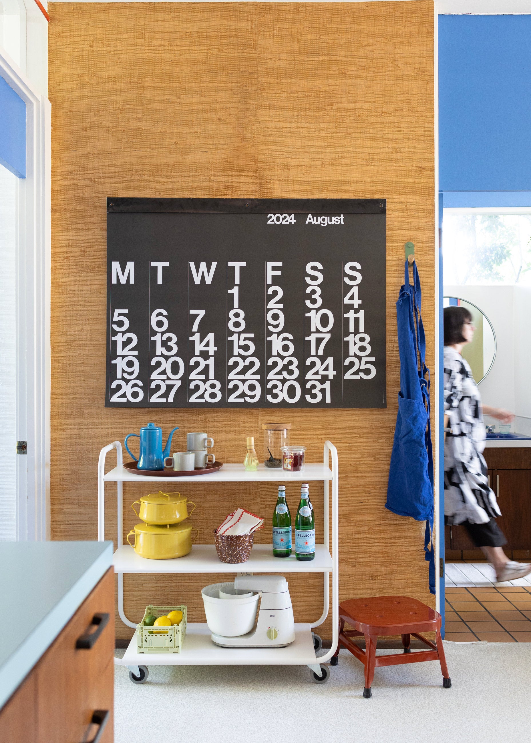 Large calendar over utility cart. 