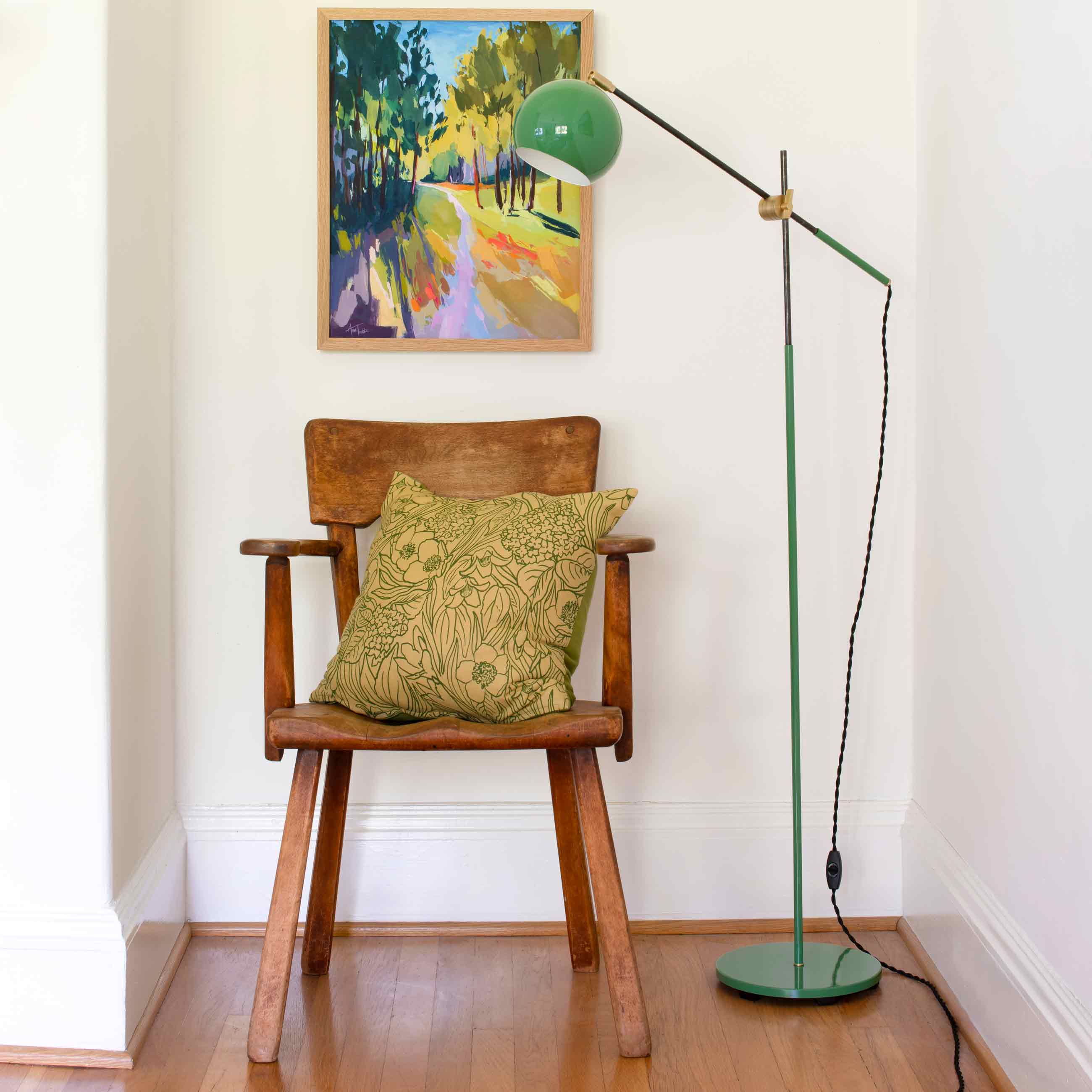 Floral pillow on a wooden chair.