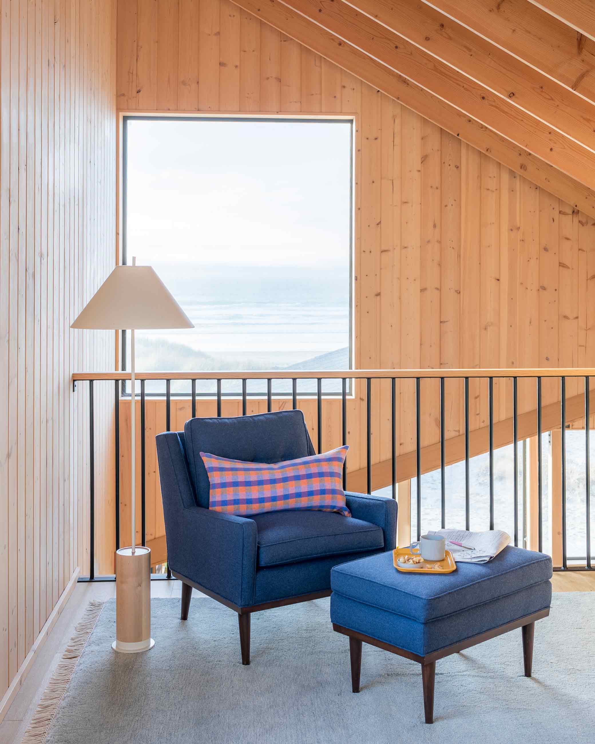 Blue armchair in ocean house loft space.