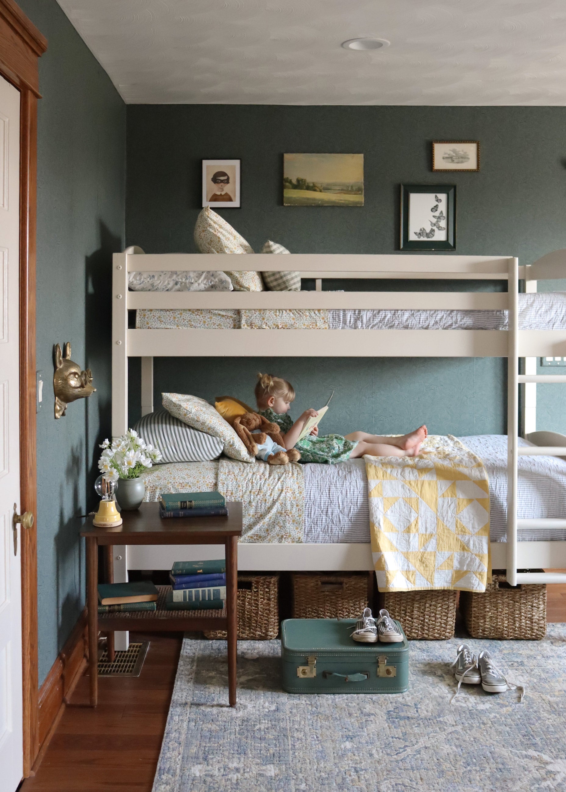 Child reading on bunk bed.