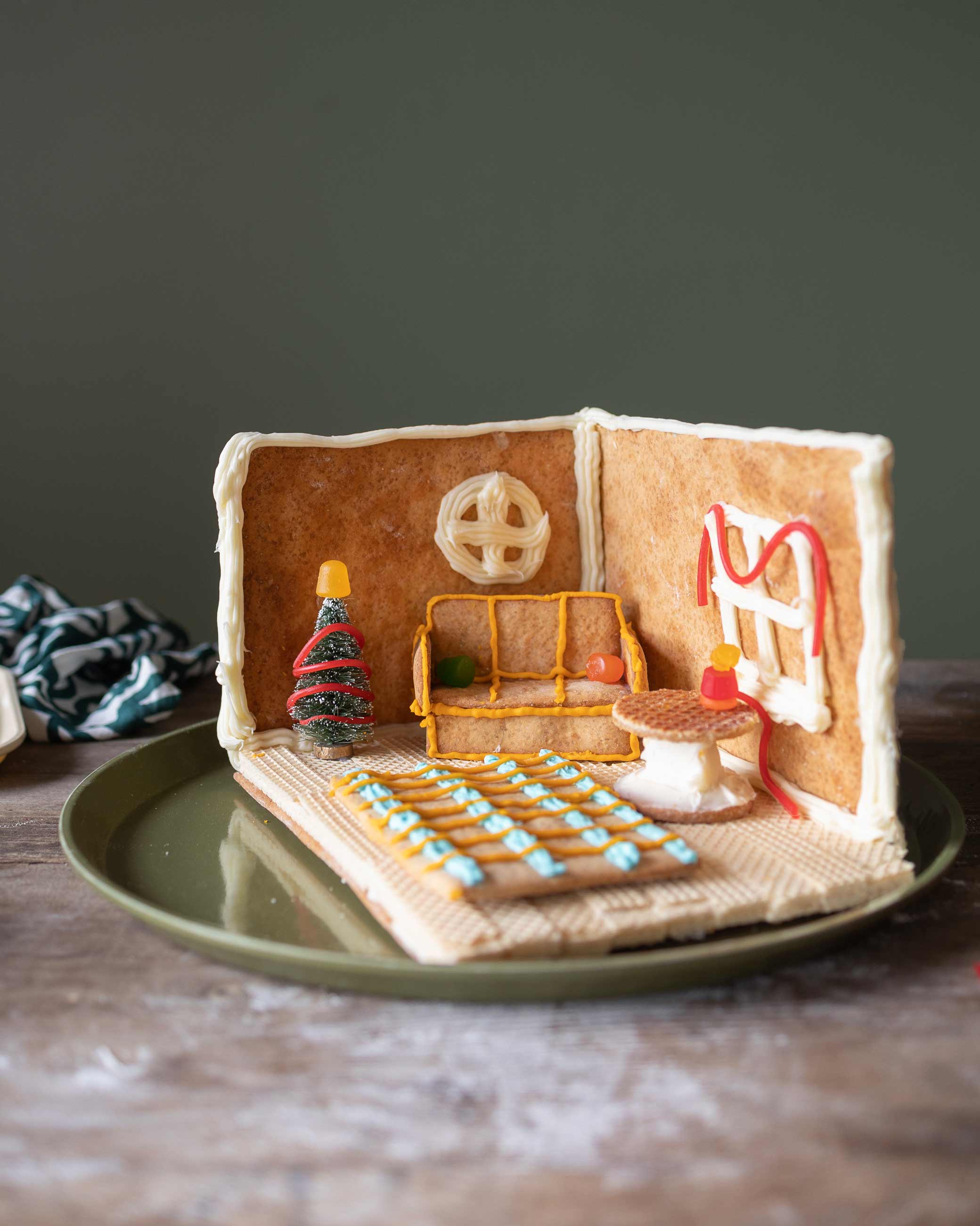 Close up shot of gingerbread room complete with gingerbread couch, rug, and table.