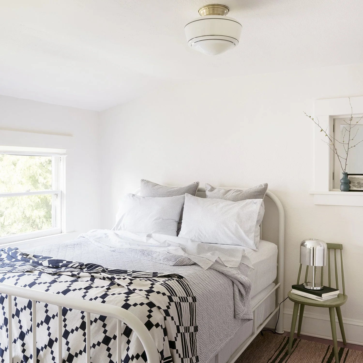 The winter + summer coverlet on a cozy bed.