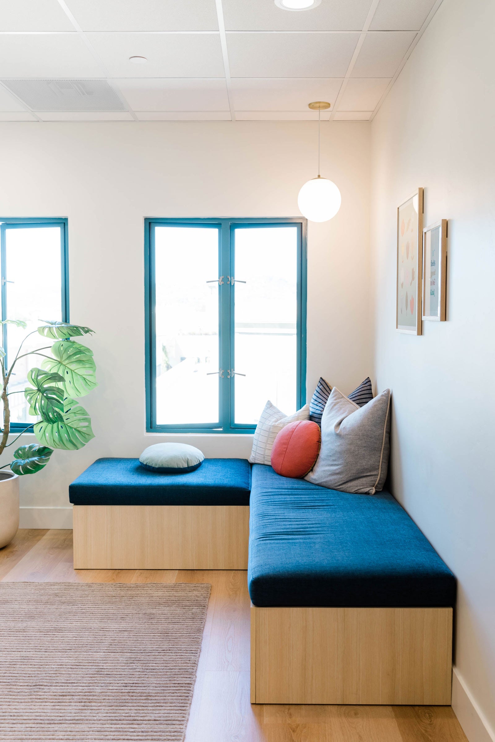 Cozy corner seating area with globe pendant in a dental office.