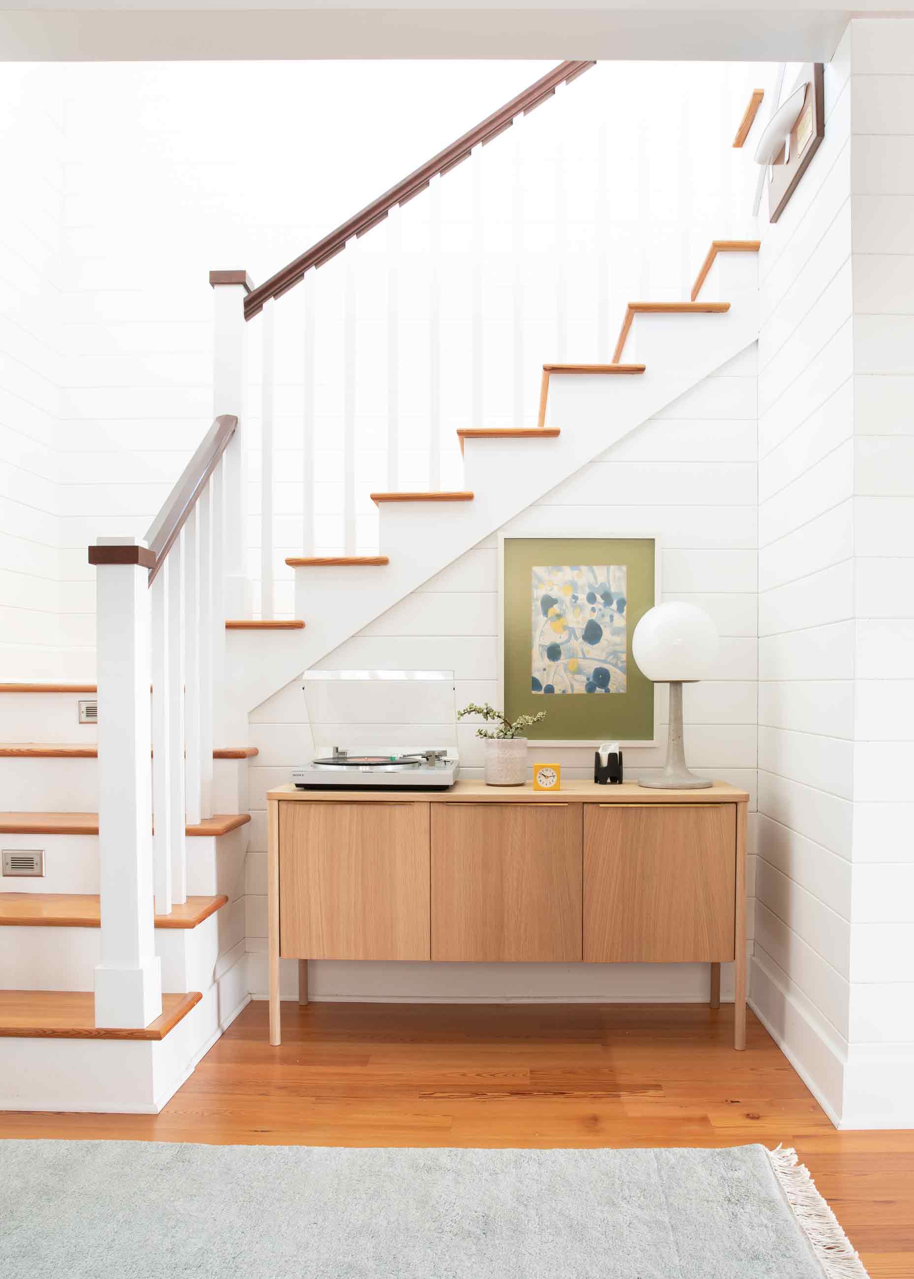 Credenza in front of staircase.