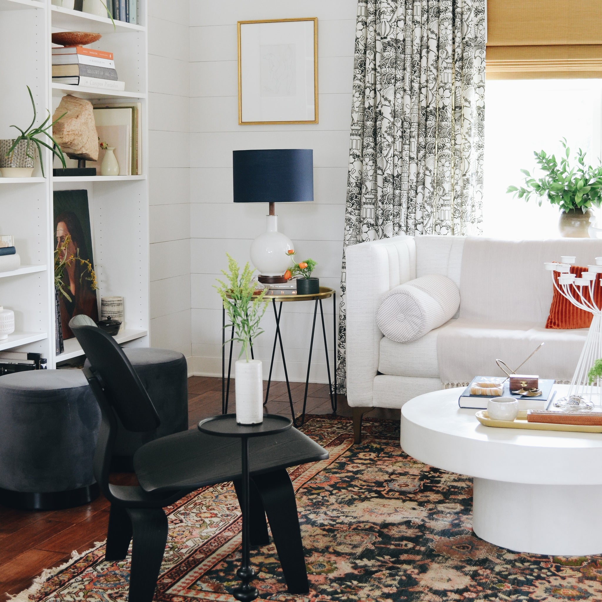 black chair and white couch in a living room