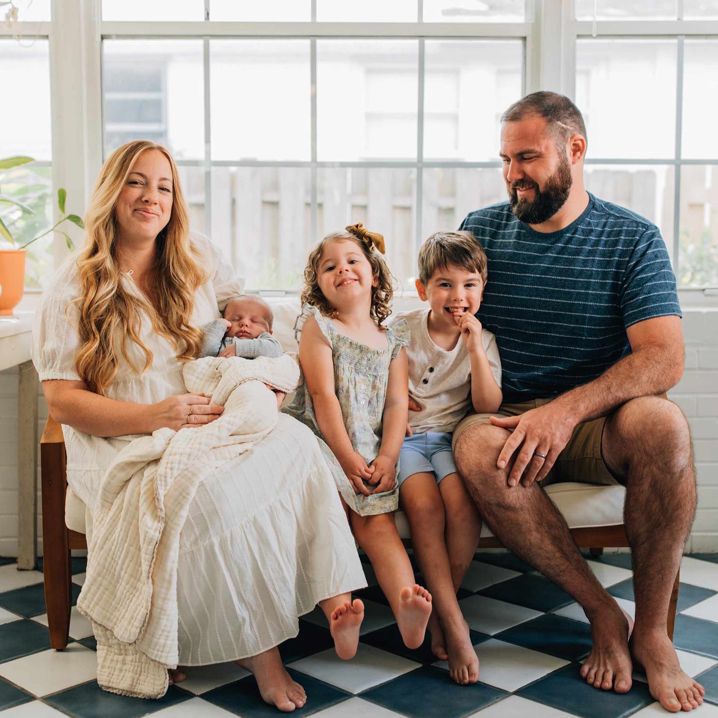 Dani Colding of @thecoldcraftsman with her family in a sunroom. 