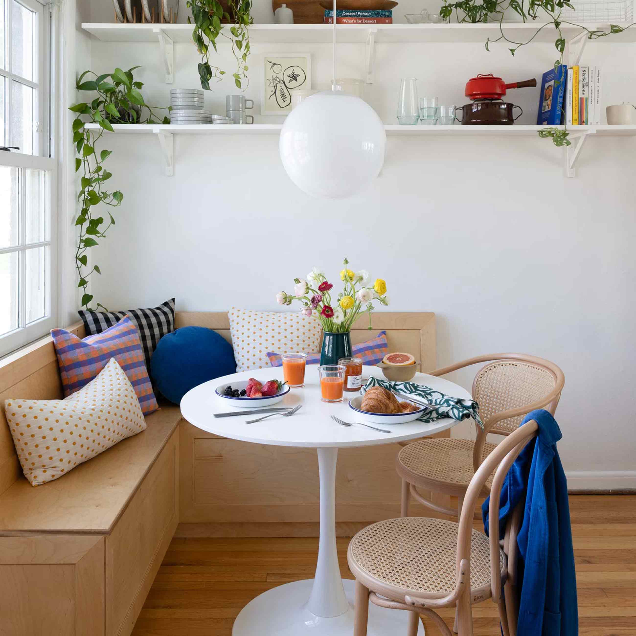 Bright and cheery dining nook with cane chairs. 