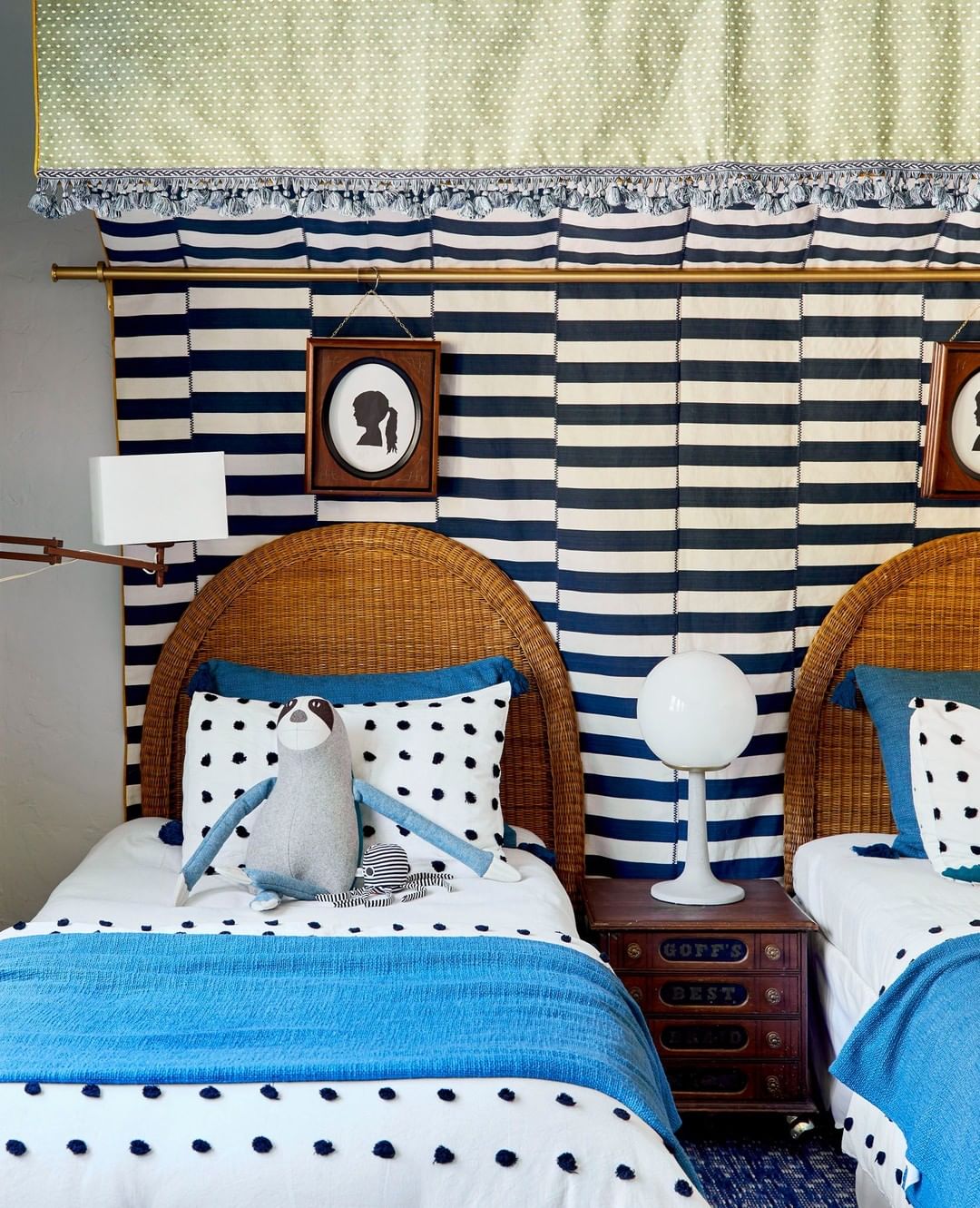 bed with a blue and white blanket and a pillow on it