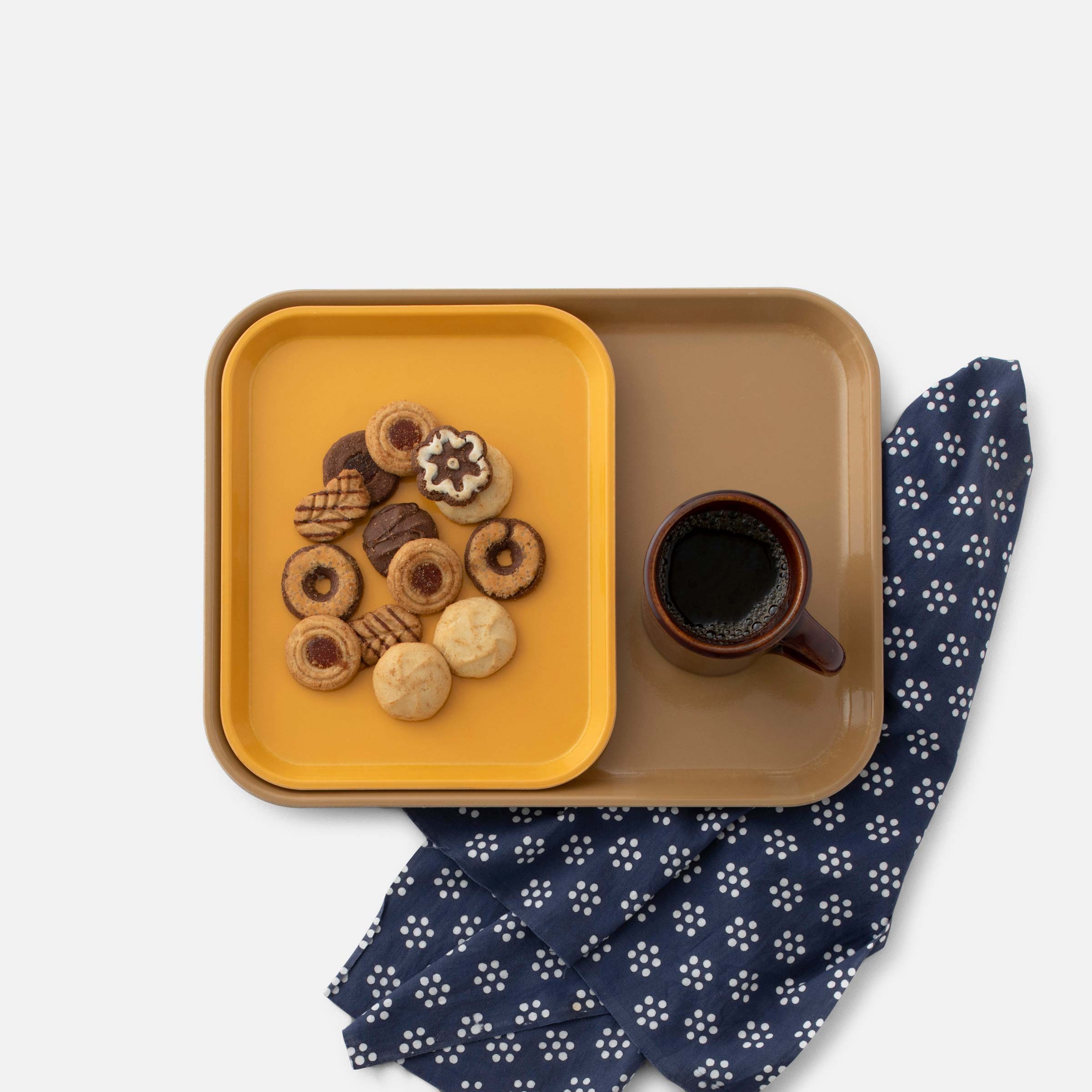 Everyday nesting tray with holiday cookies and a mug on top.