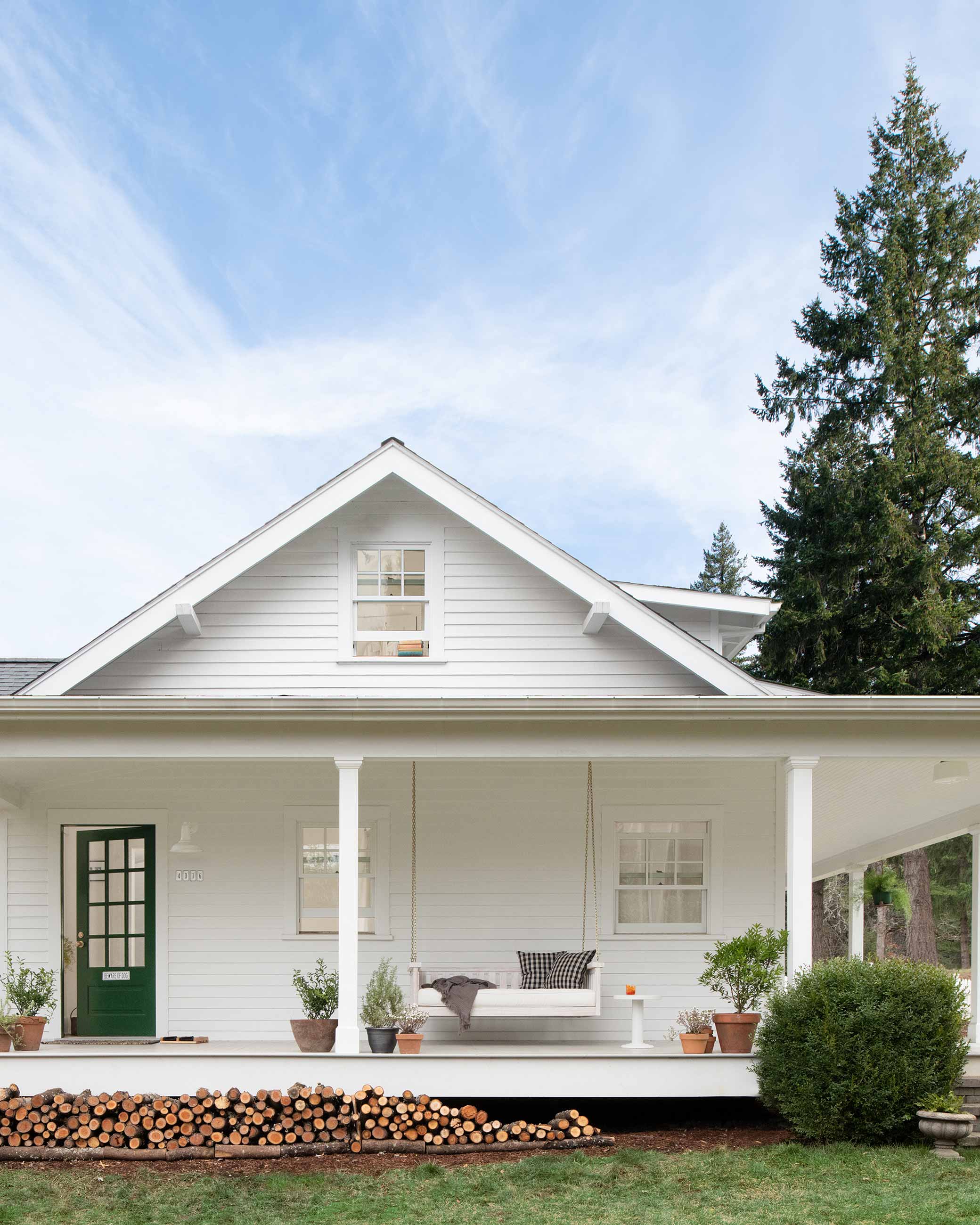 Farmhouse style front porch with green door