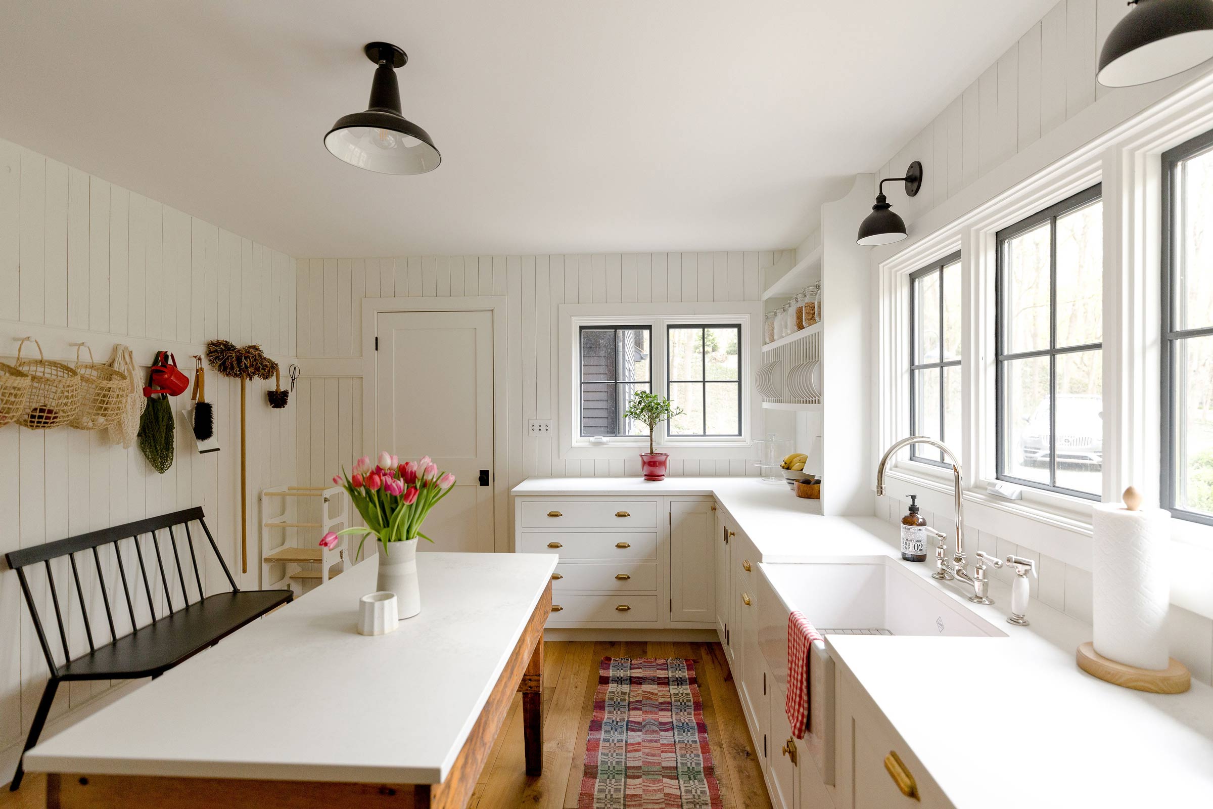 Factory-style light fixtures in a modern, open kitchen. 