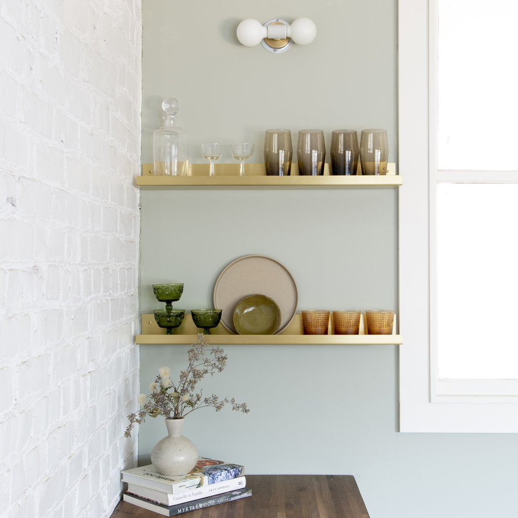 gold shelf with dishes on it