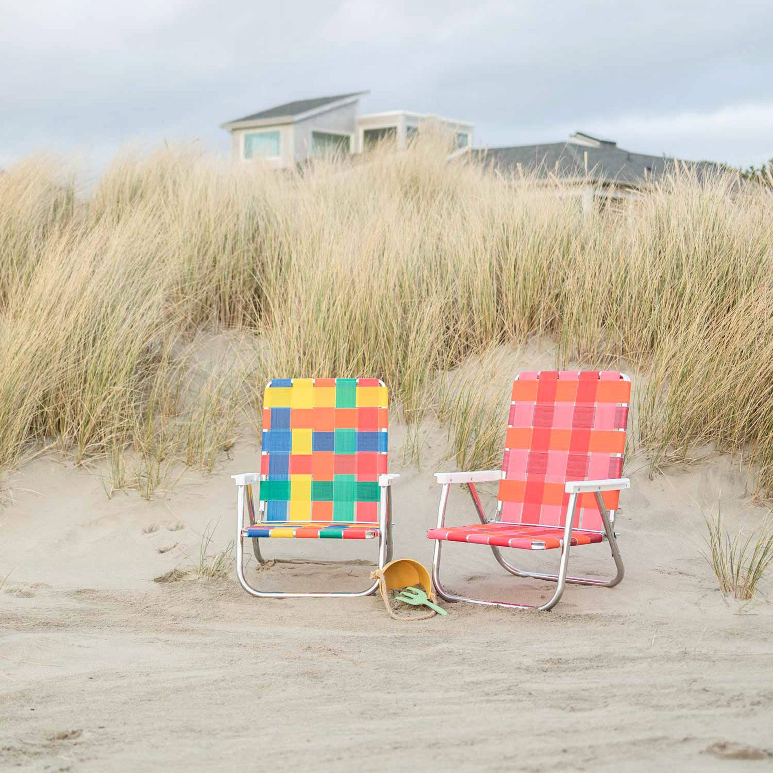 Two beach chairs on beach dune.