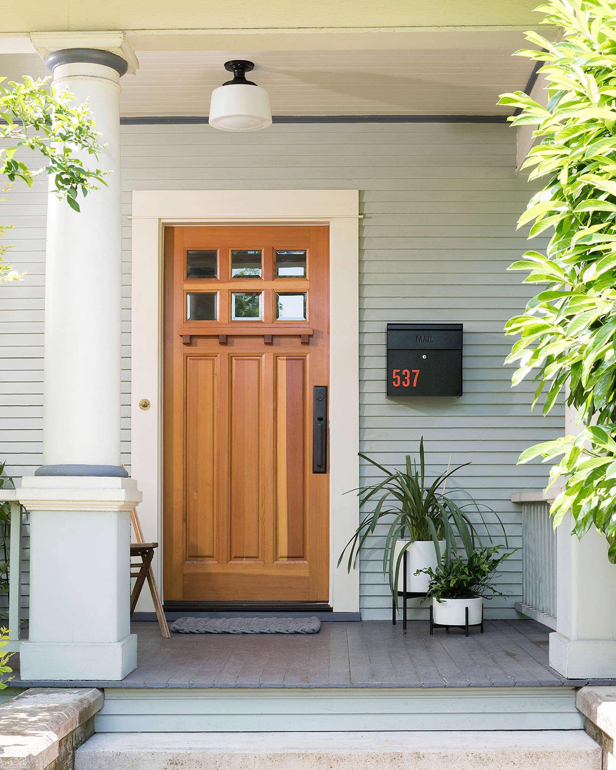 Front door with surface mount light and modern door hardware