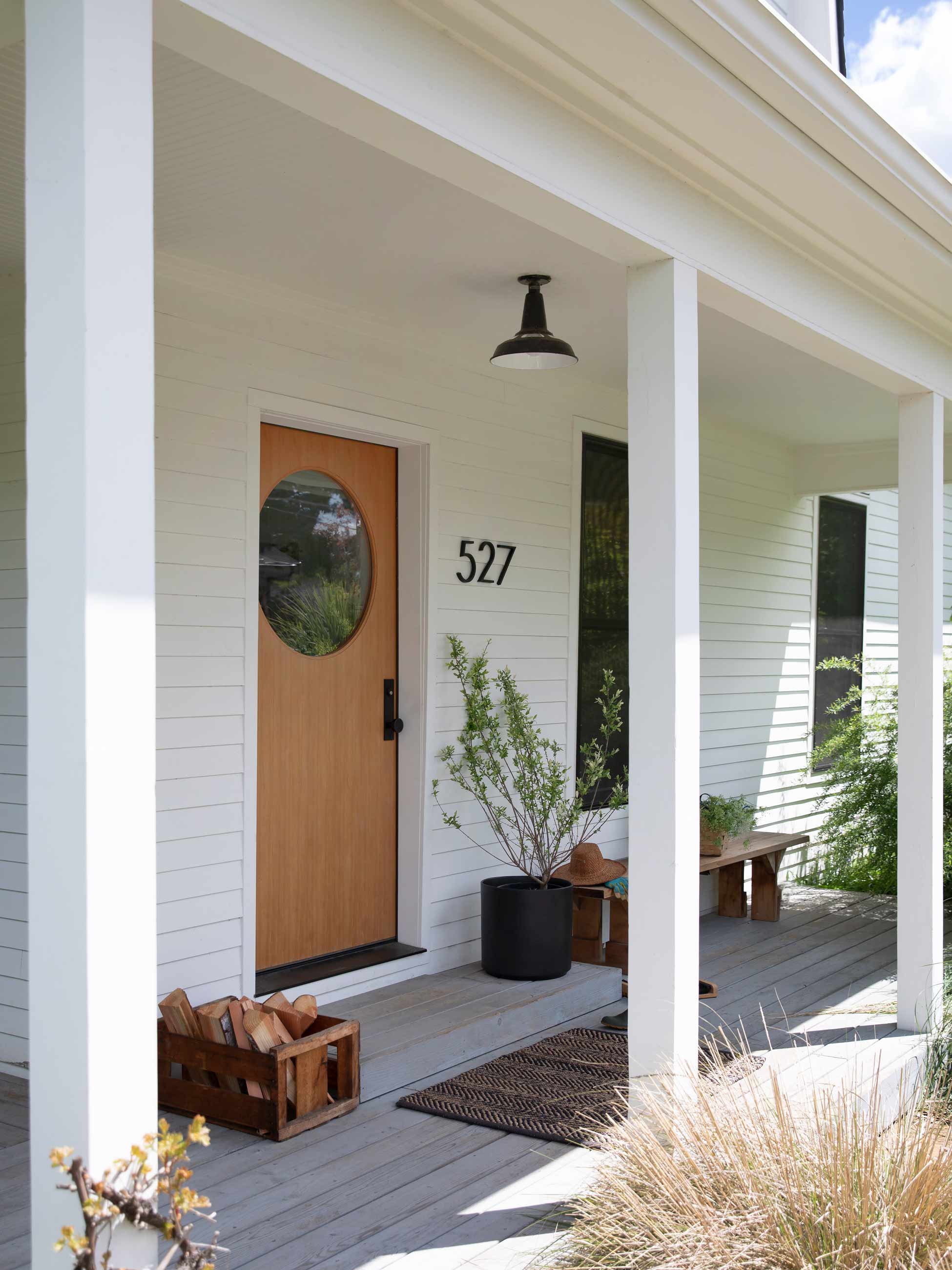 Styled porch of a modern, white house.