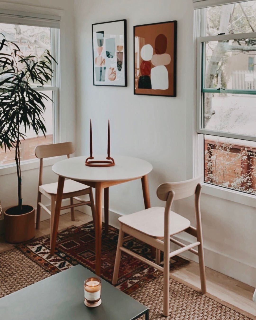 table with chairs and a couple of candles on it