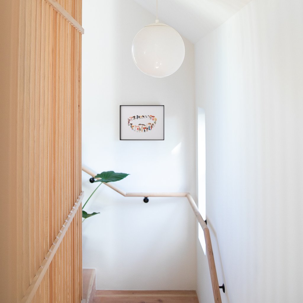 white wall with a light fixture above staircase