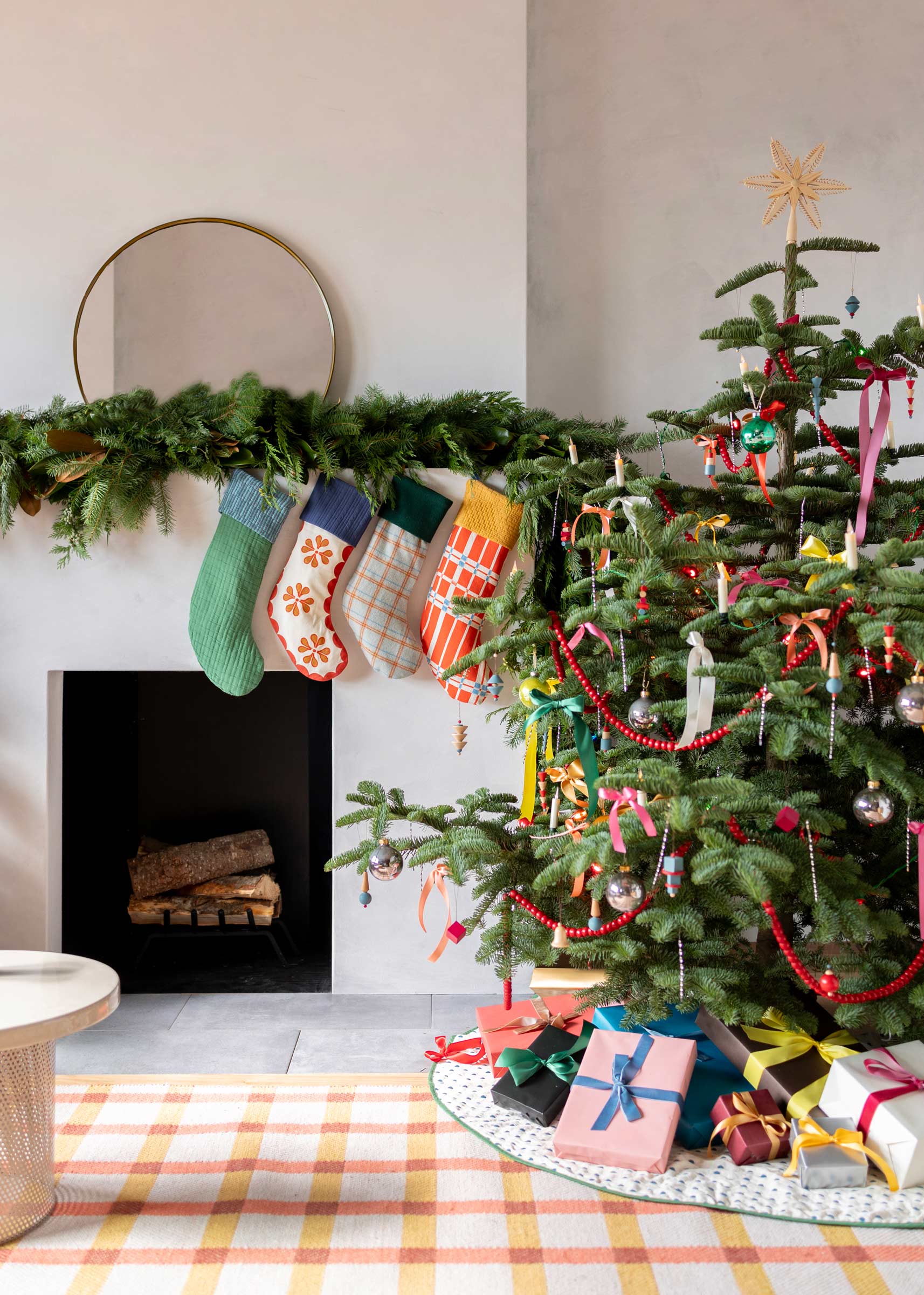 Holiday stockings over a modern fireplace.