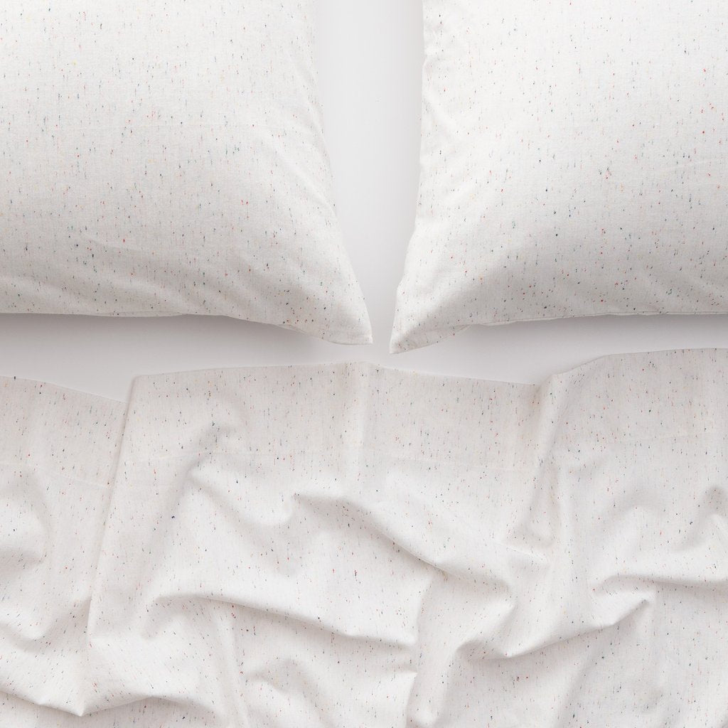 white bedspread and two white pillows