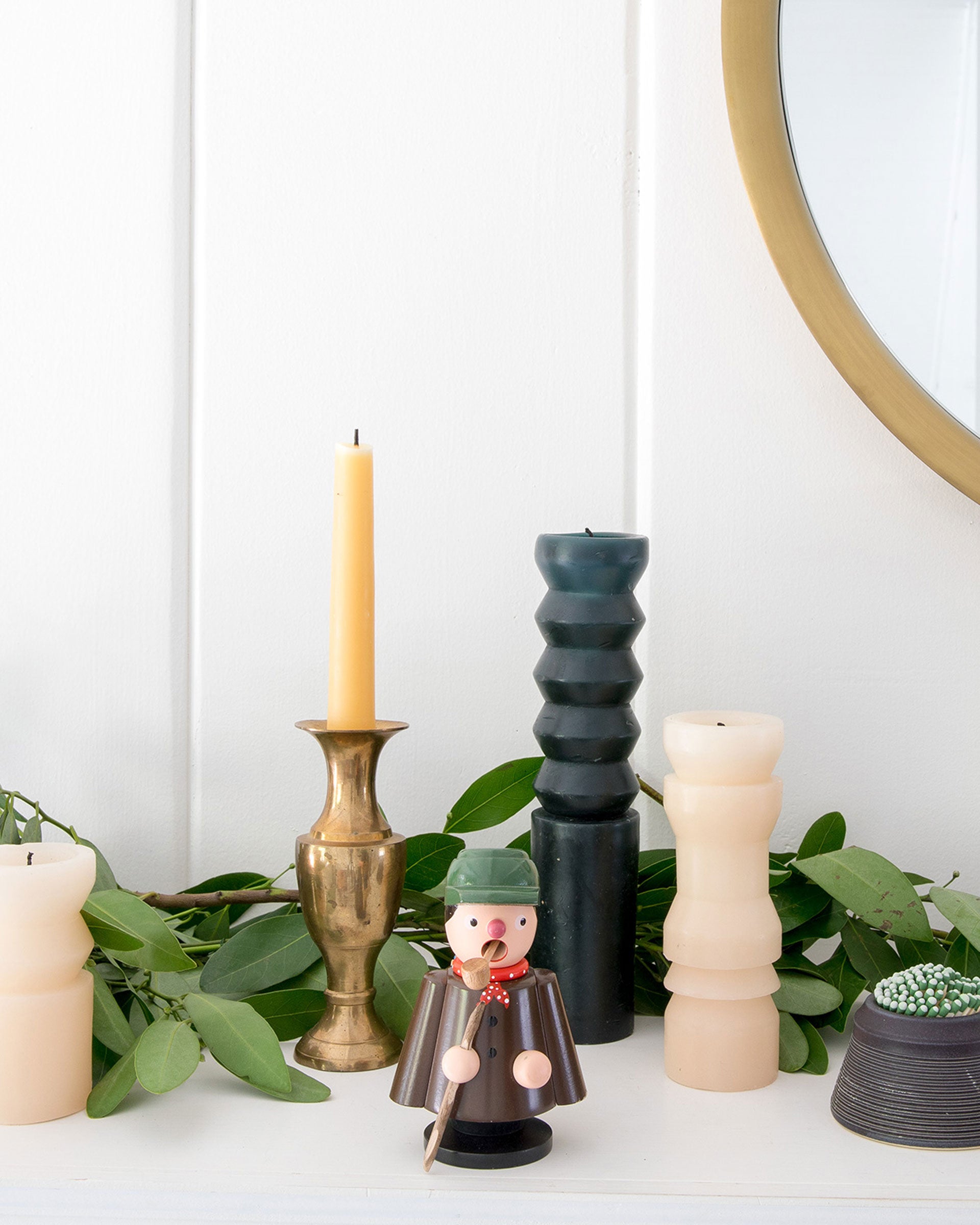 A handmade German incense smoker on a mantel.