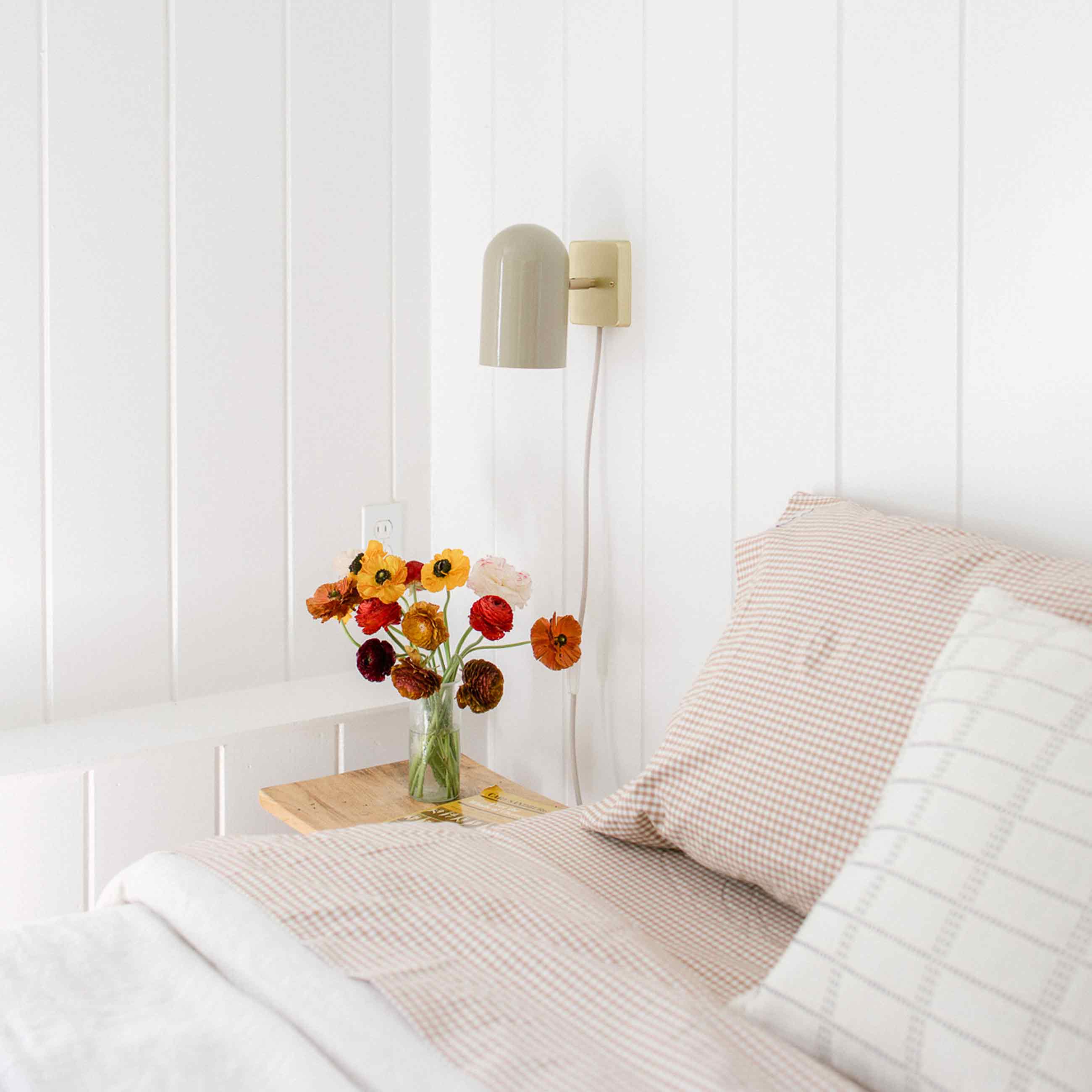 Gingham sheets on a bed. 