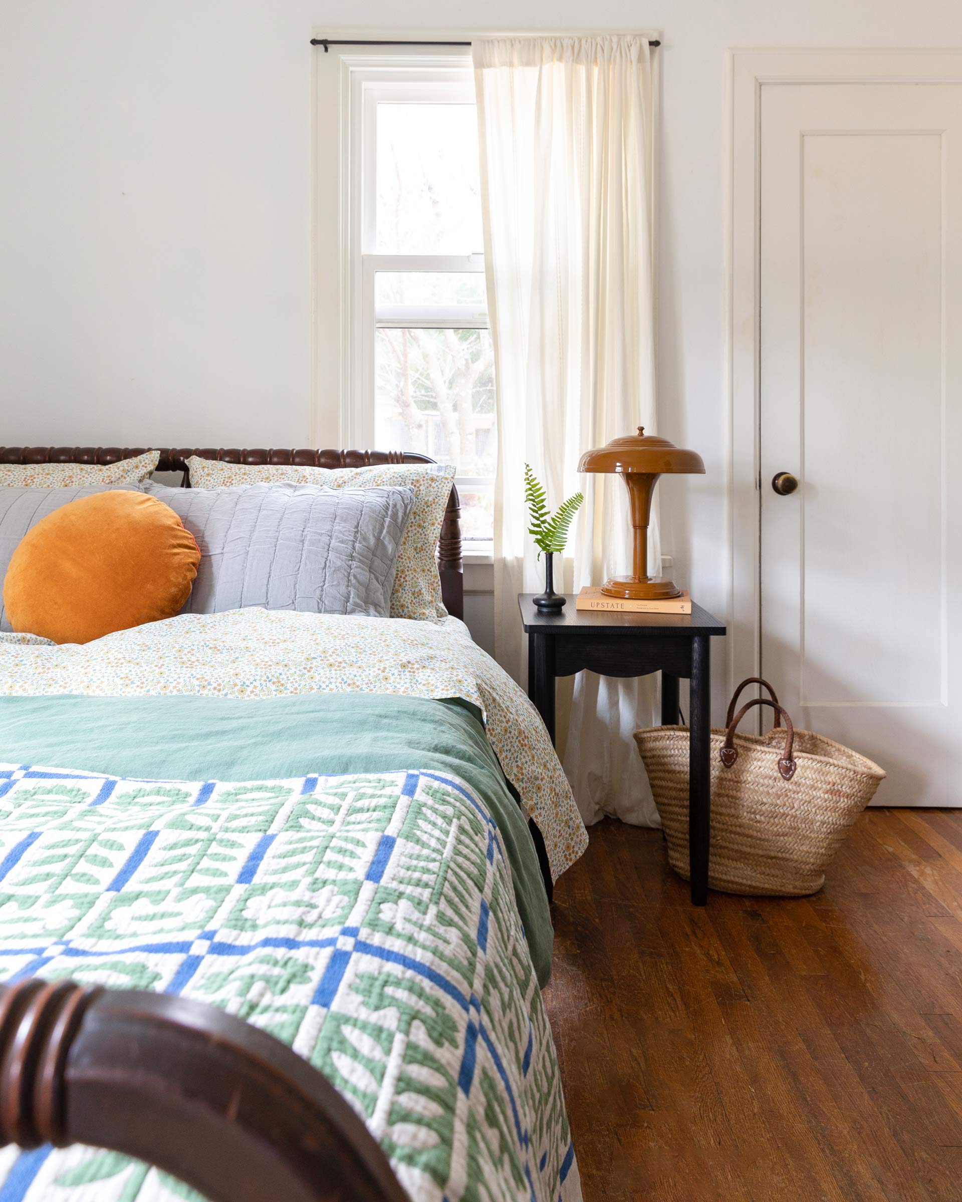 Colorful bedding and throw pillows in a room. 