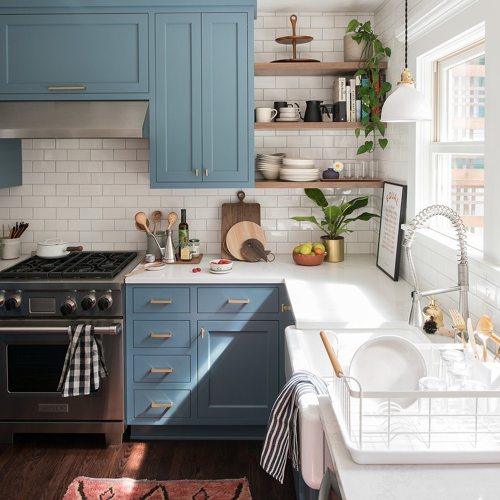 kitchen with blue cabinets and plants